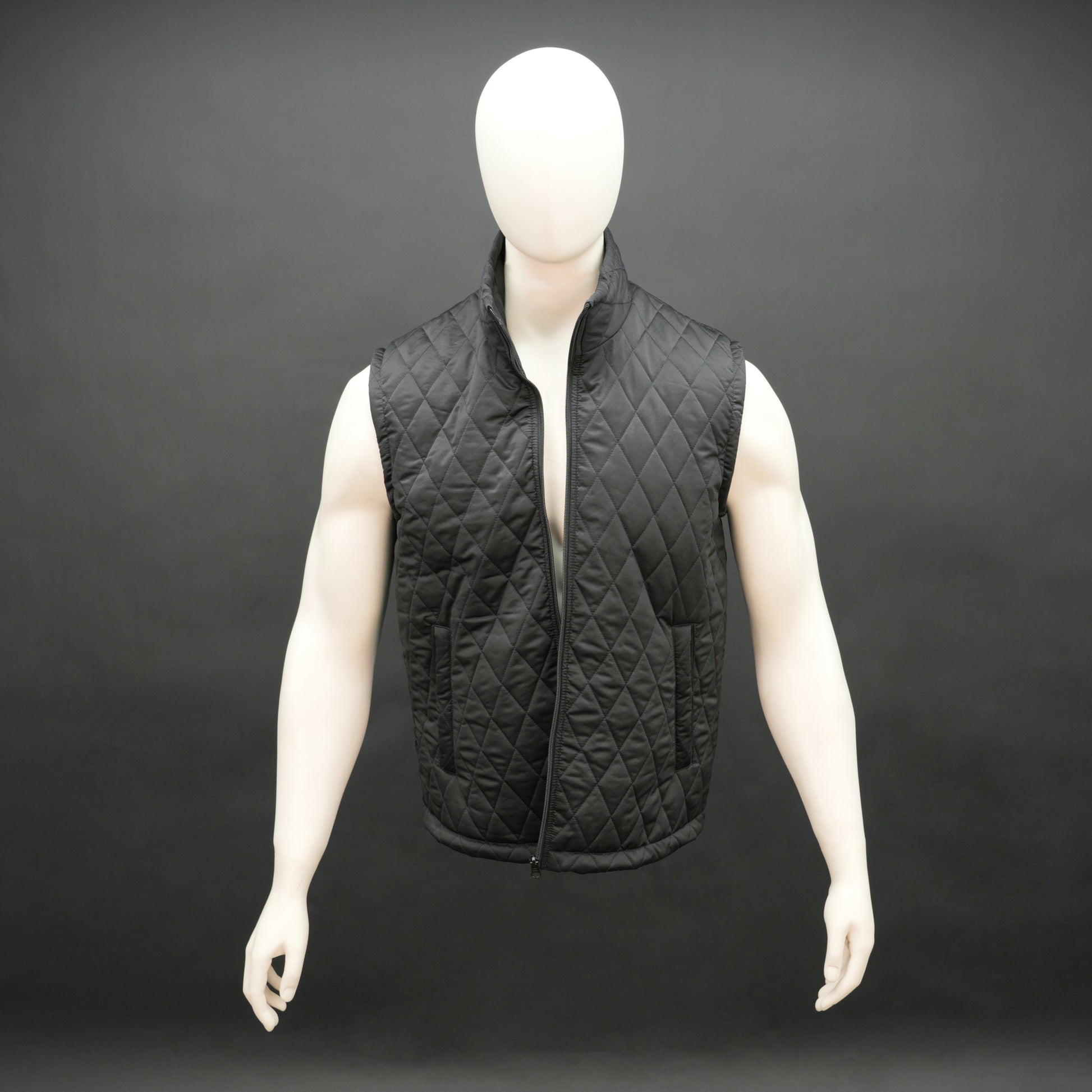 Lightweight black quilted sleeveless  puffer vest with zip closure, side and inside pockets, ideal for layering