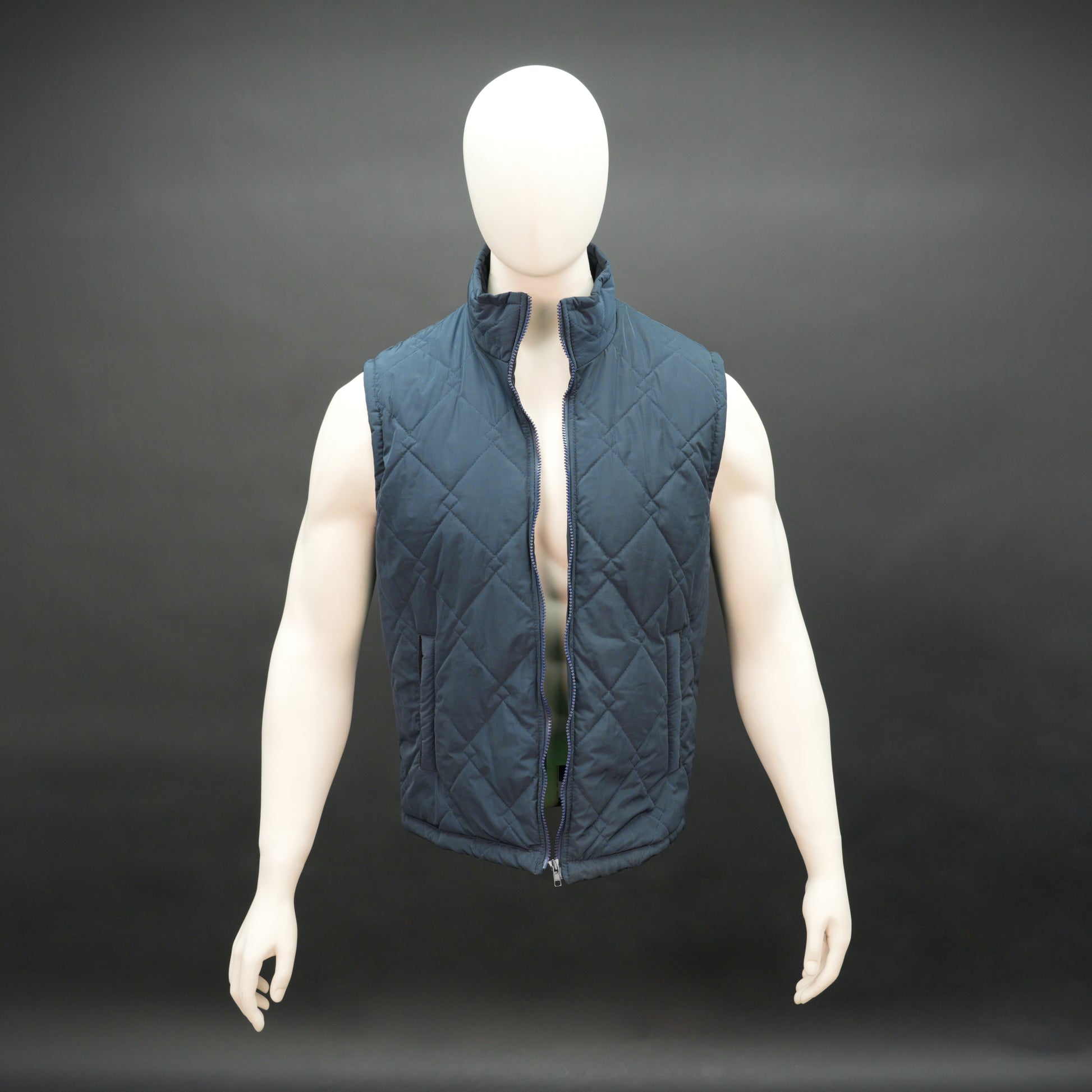 Lightweight navy sleeveless puffer vest with zip closure, side and inside pockets, for layering