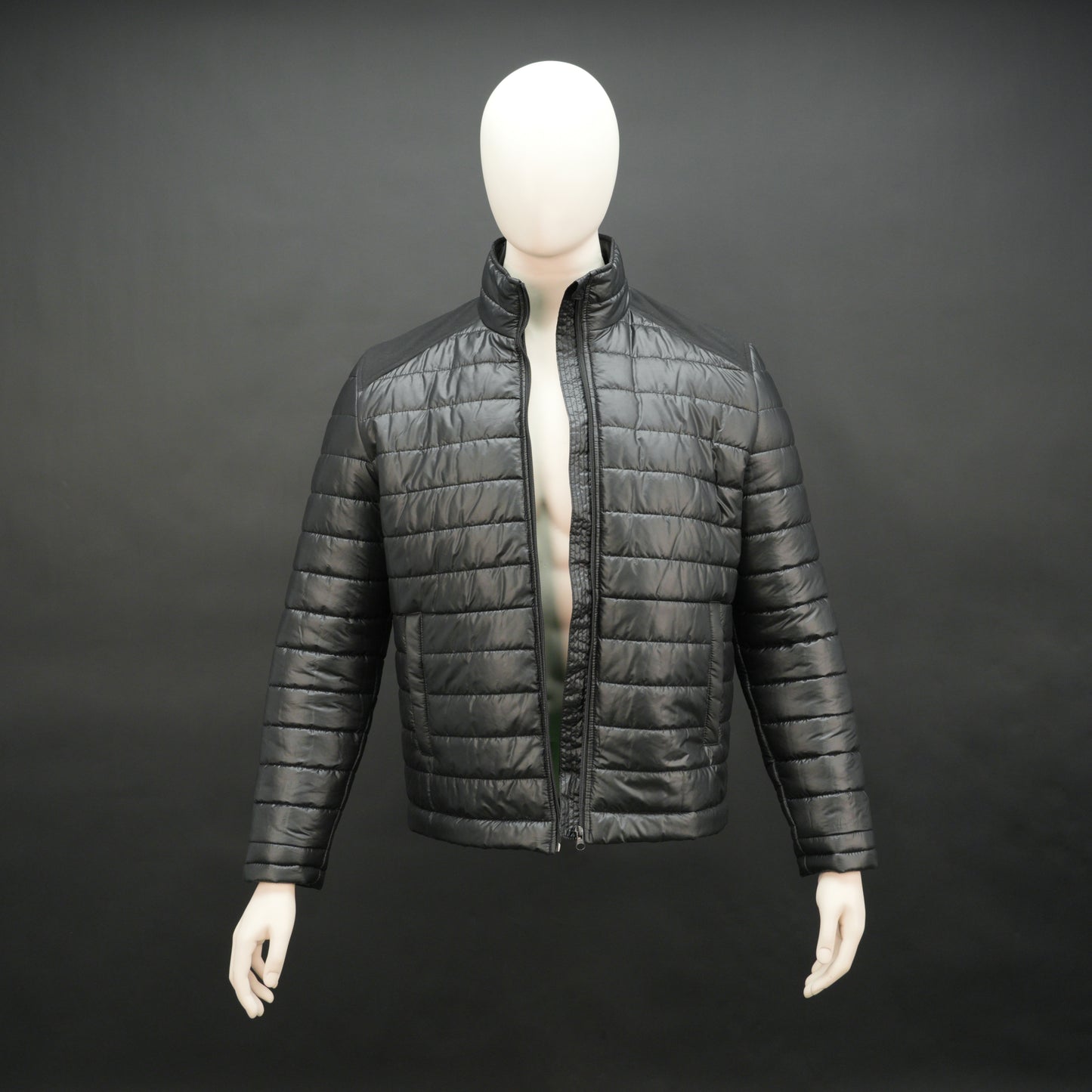 Black full-sleeve two-tone puffer jacket with snap pockets, quilted insulation, inner compartments, and zip closure