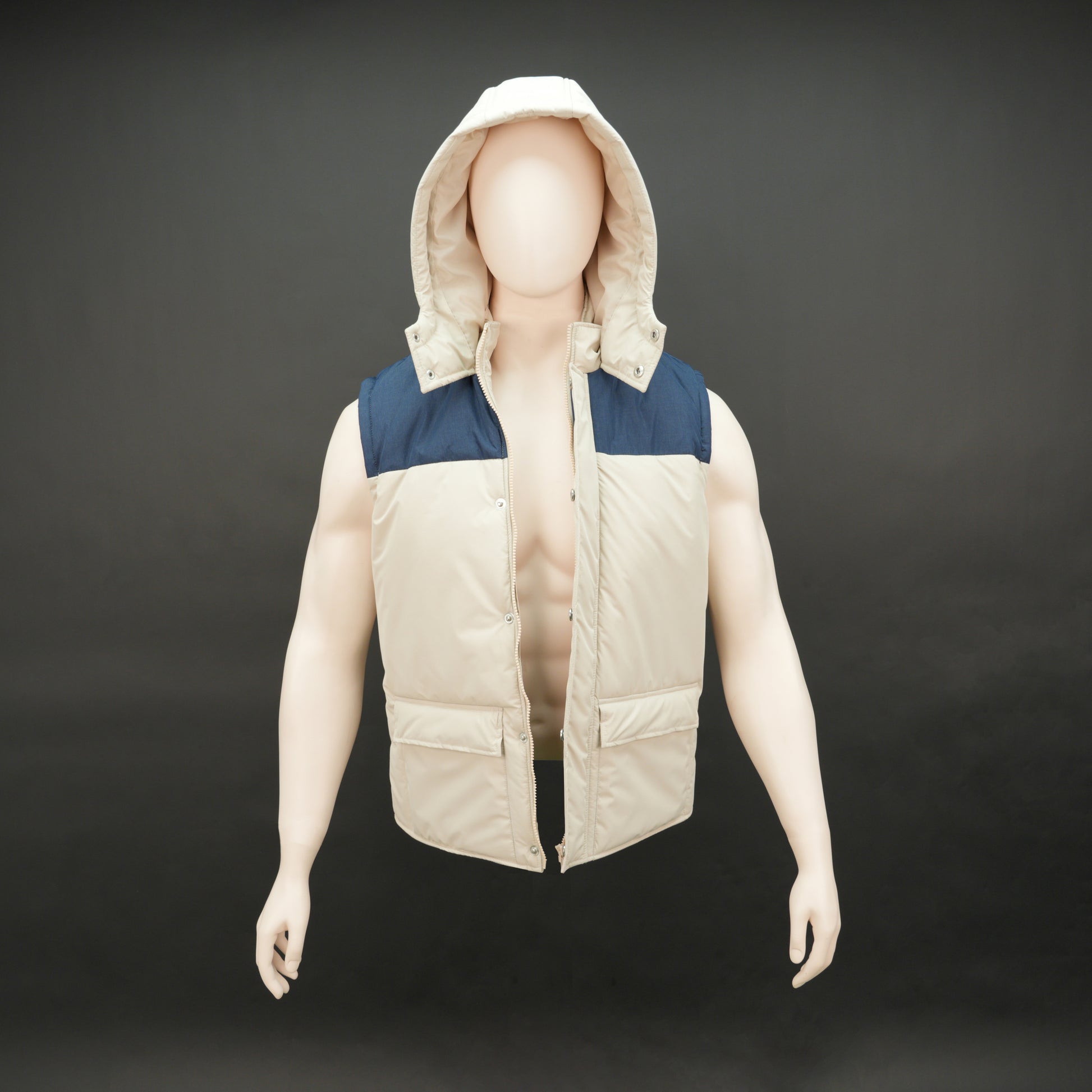 Cream-blue two-tone sleeveless puffer jacket with zip and snap closure, hood, side and inner pockets, quilted for layering