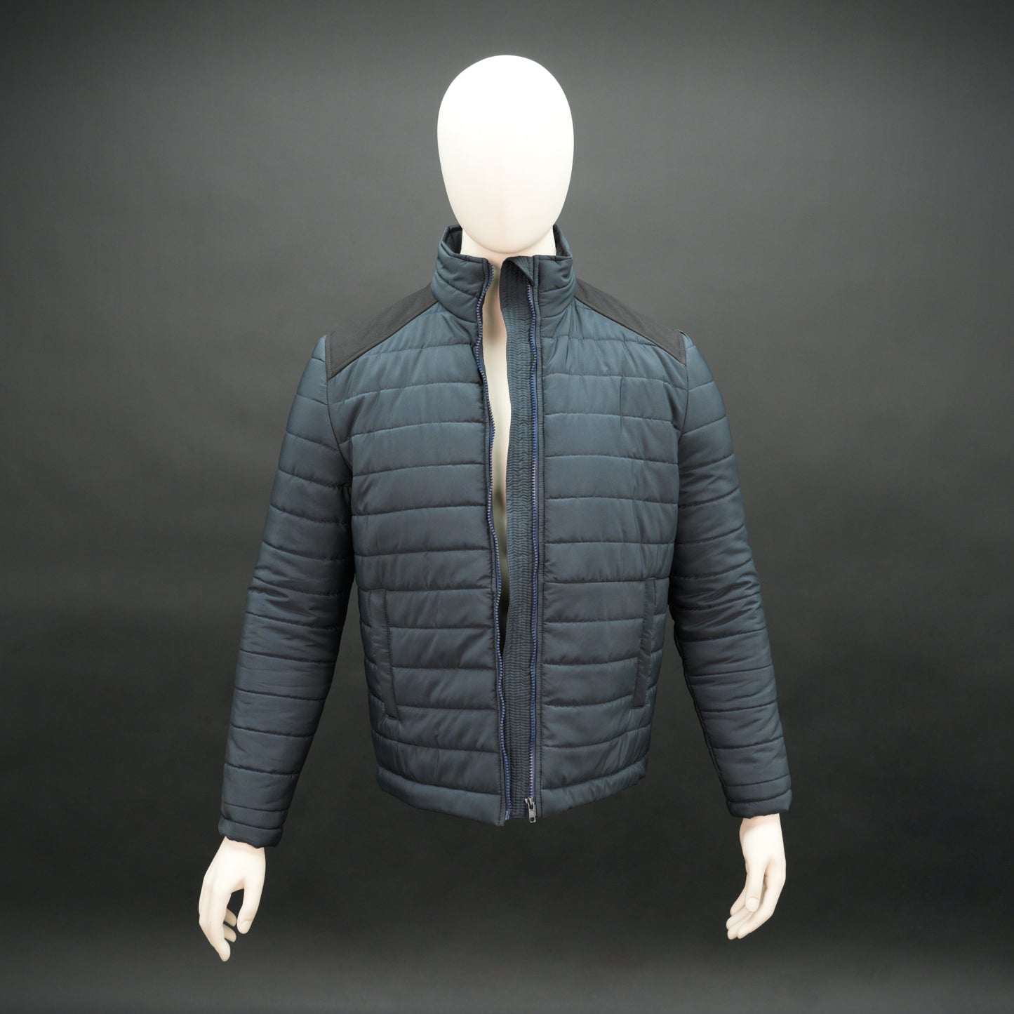 Navy full-sleeve two-tone puffer jacket with snap pockets, quilted insulation, inner compartments, and zip closure
