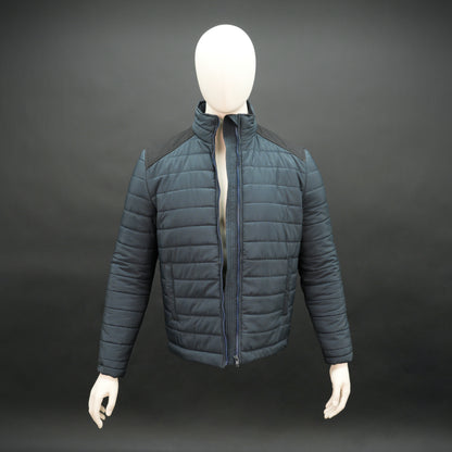 Navy full-sleeve two-tone puffer jacket with snap pockets, quilted insulation, inner compartments, and zip closure