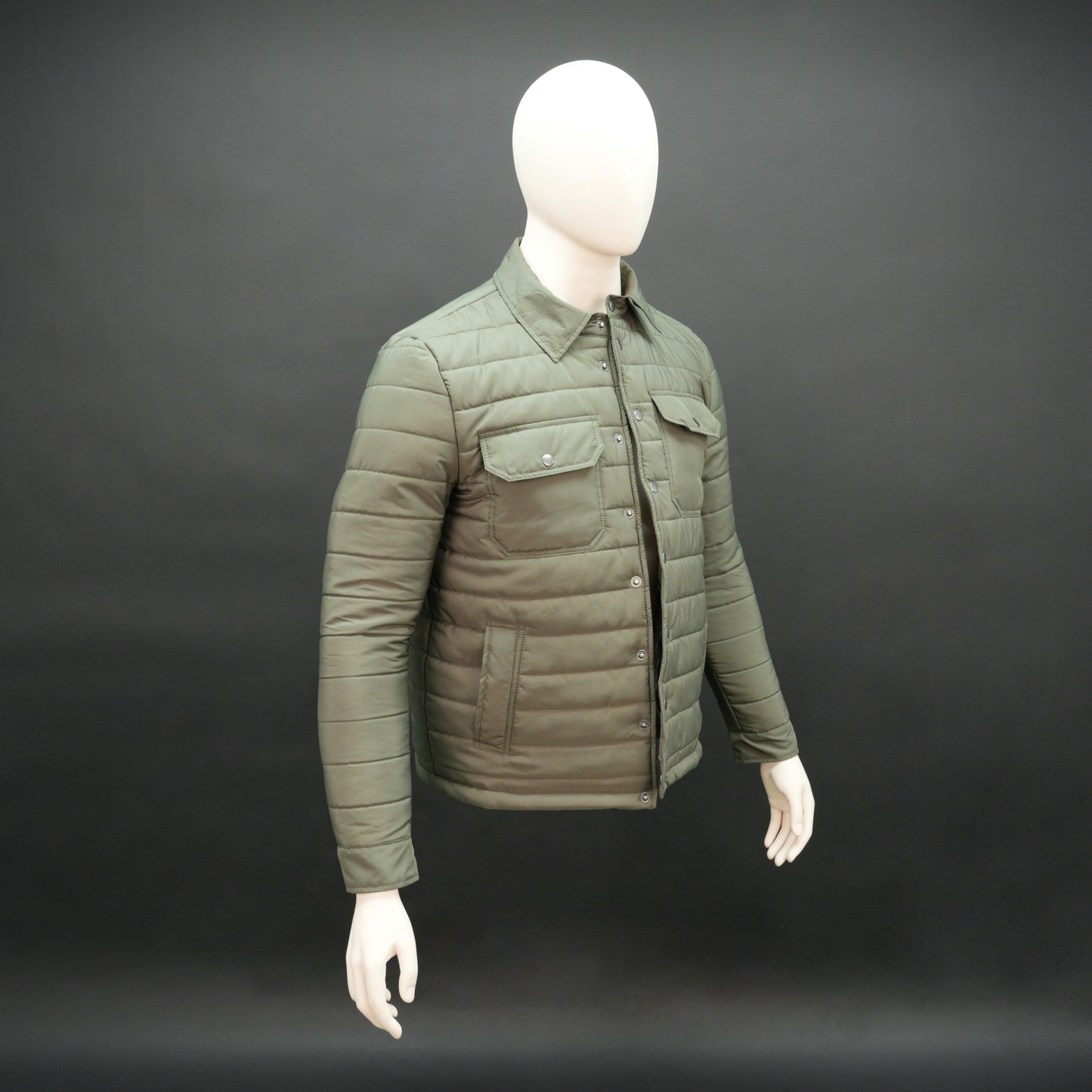 Green full-sleeve puffer jacket with snap closure, quilted padding, inner and outer pockets, designed for everyday comfort.