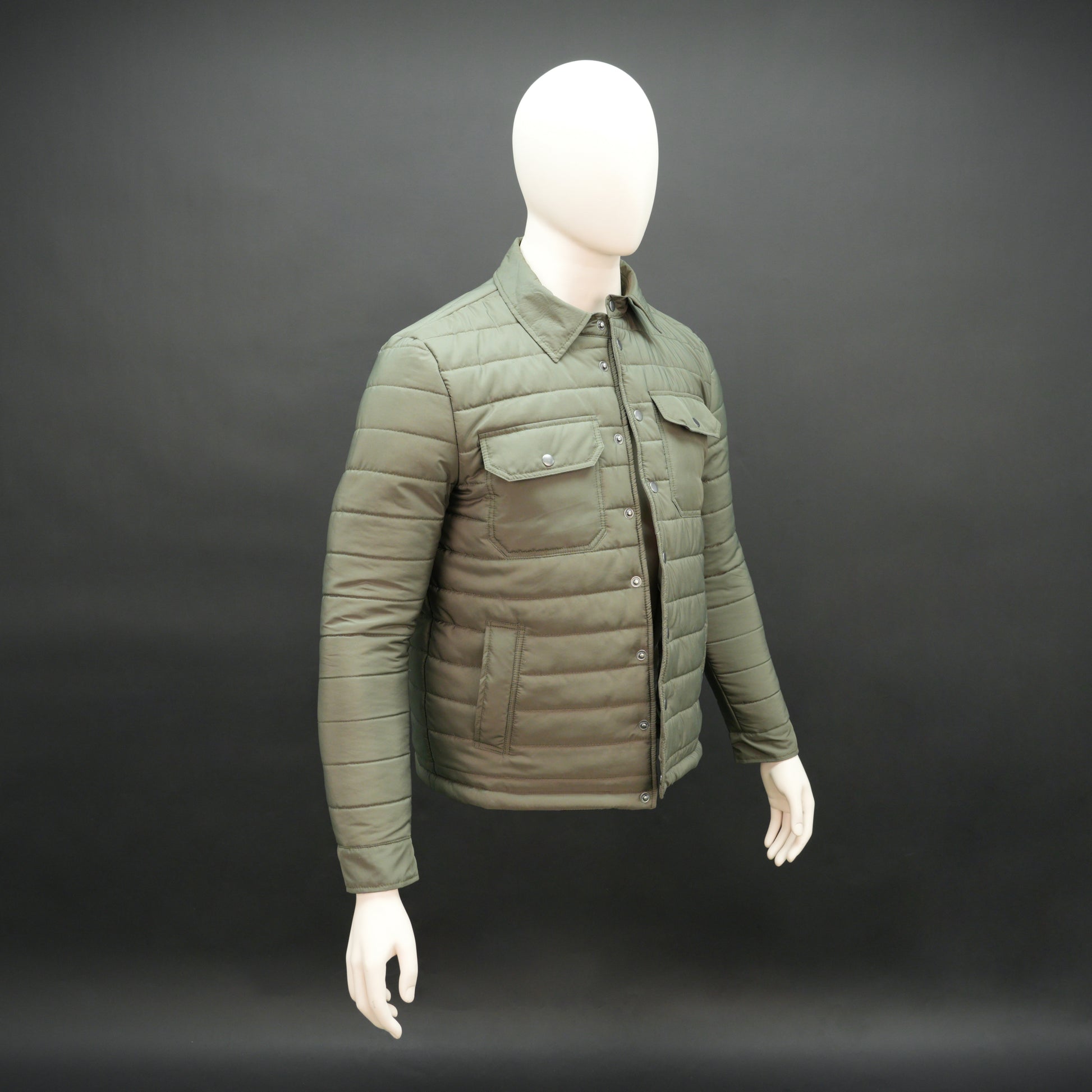 Green full-sleeve puffer jacket with snap closure, quilted padding, inner and outer pockets, designed for everyday comfort.