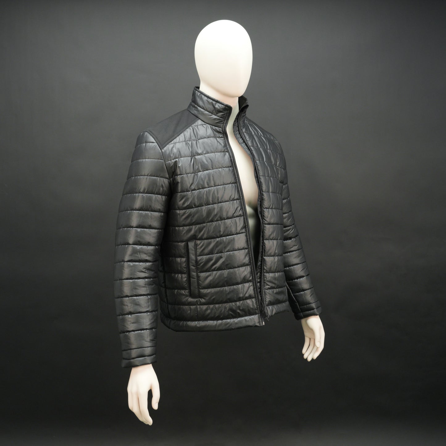Black full-sleeve two-tone puffer jacket with snap pockets, quilted insulation, inner compartments, and zip closure
