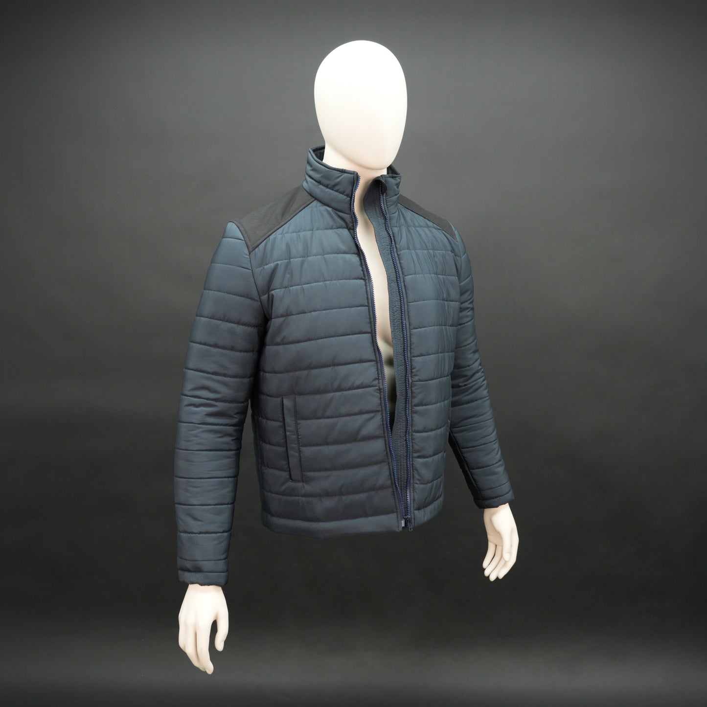 Navy full-sleeve two-tone puffer jacket with snap pockets, quilted insulation, inner compartments, and zip closure