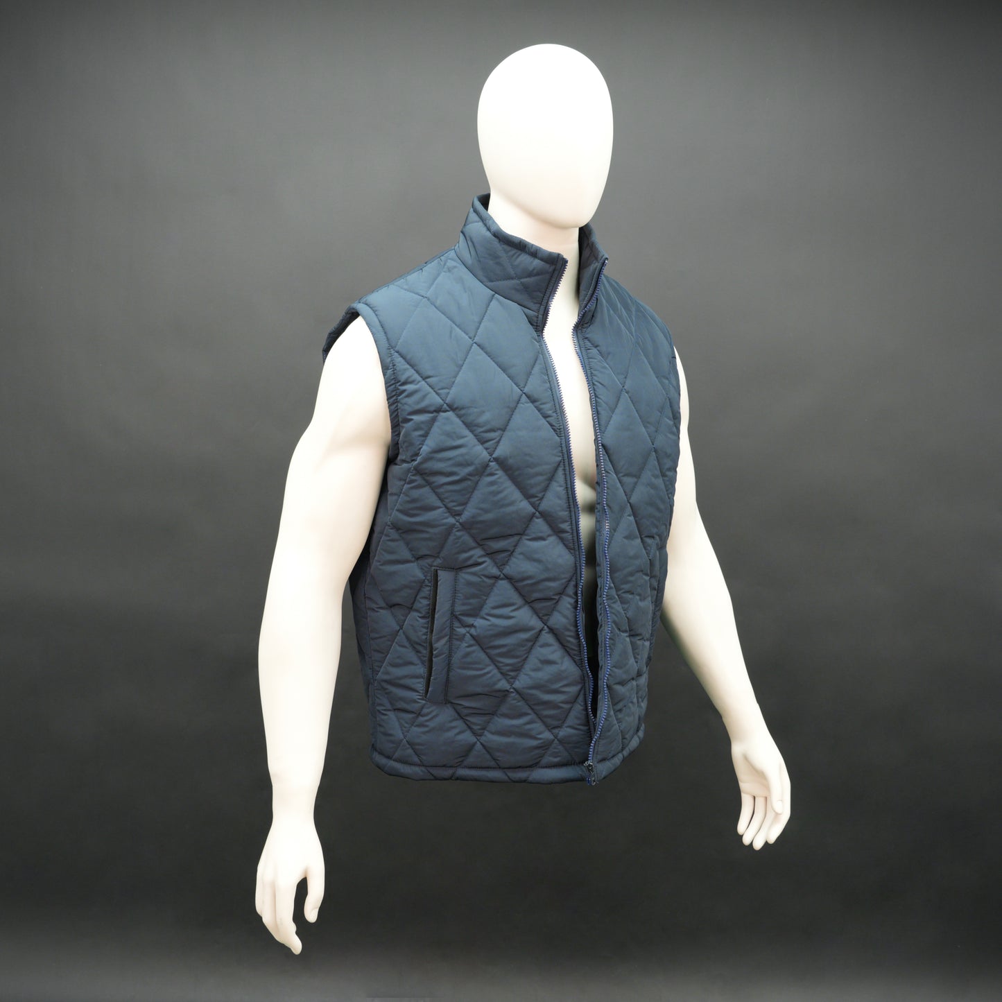 Navy sleeveless puffer vest with zip, side and inside pockets, lightweight for layering