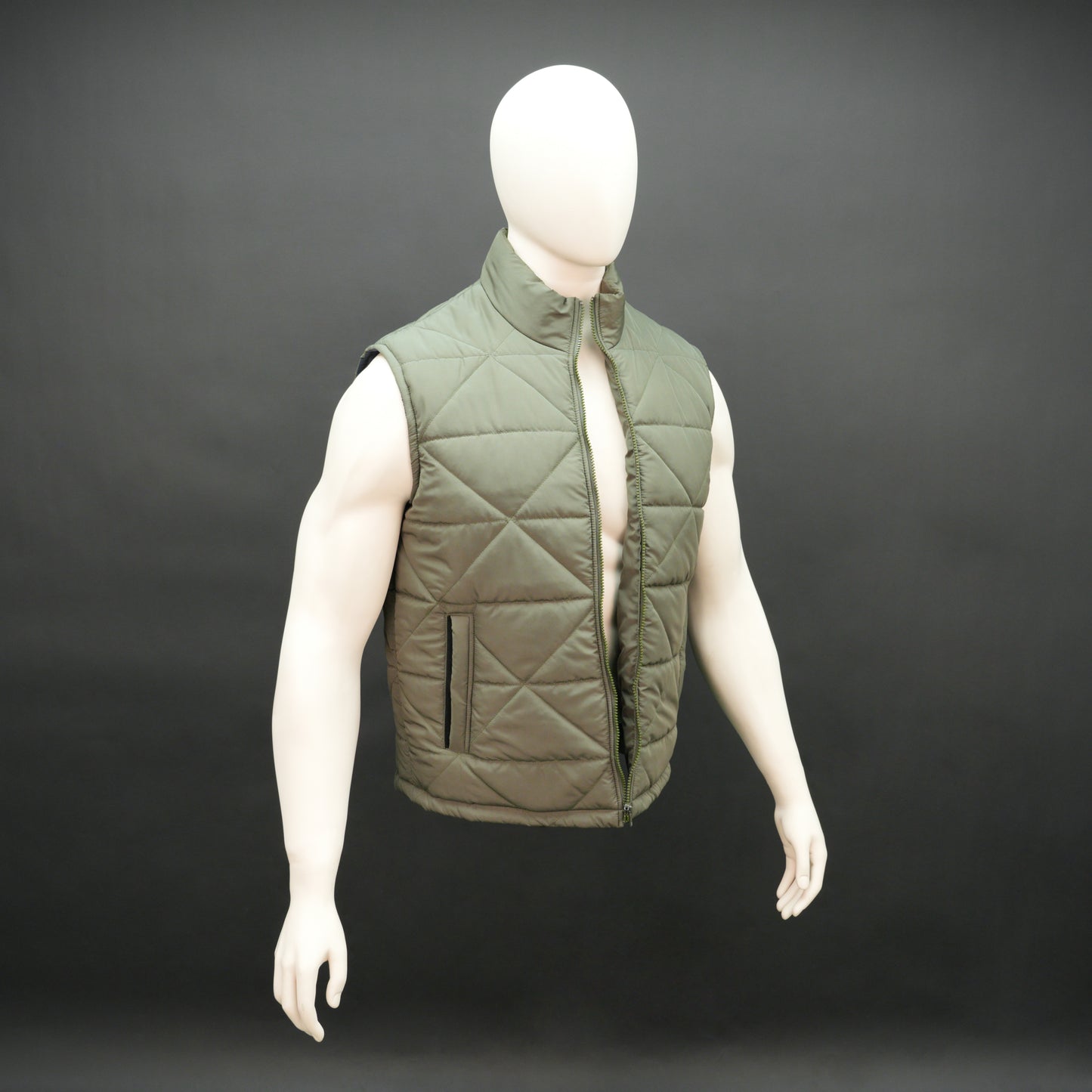 Green sleeveless puffer vest with zip closure, side and inner pockets, lightweight and ideal for layering.