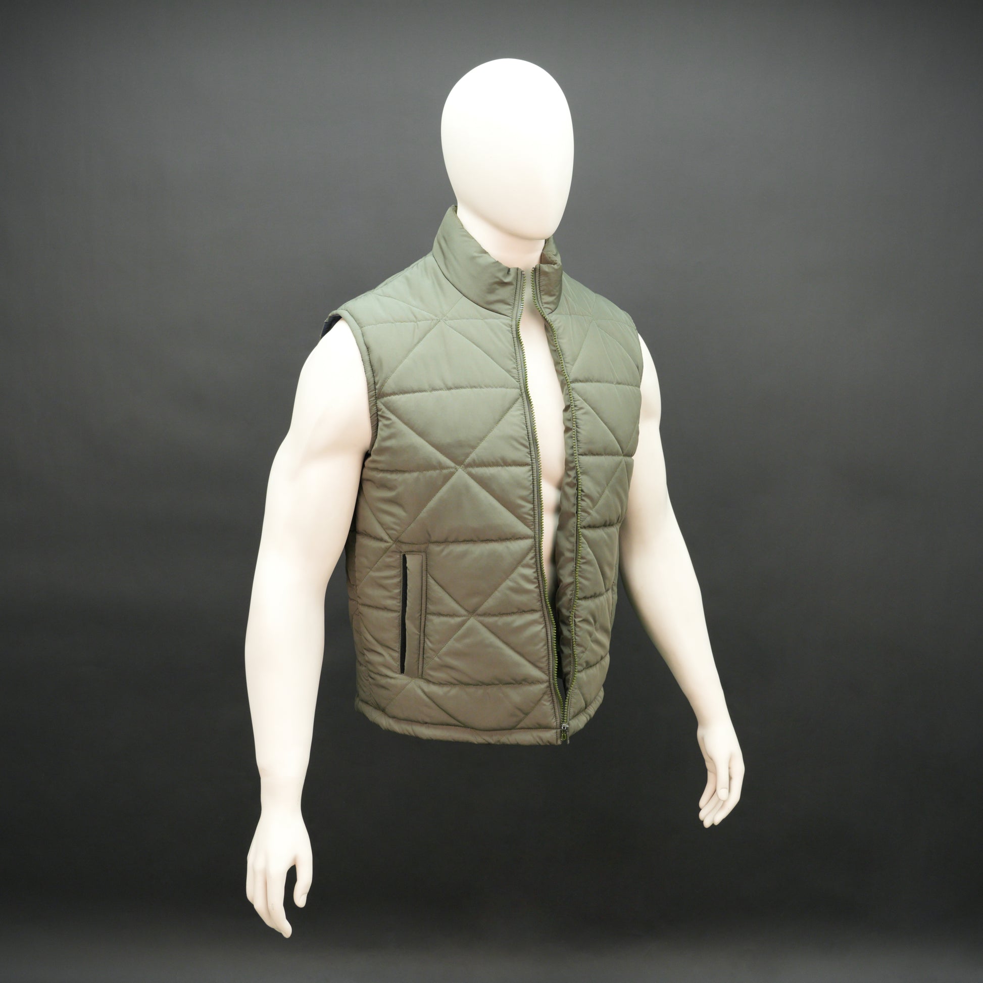 Green sleeveless puffer vest with zip closure, side and inner pockets, lightweight and ideal for layering.