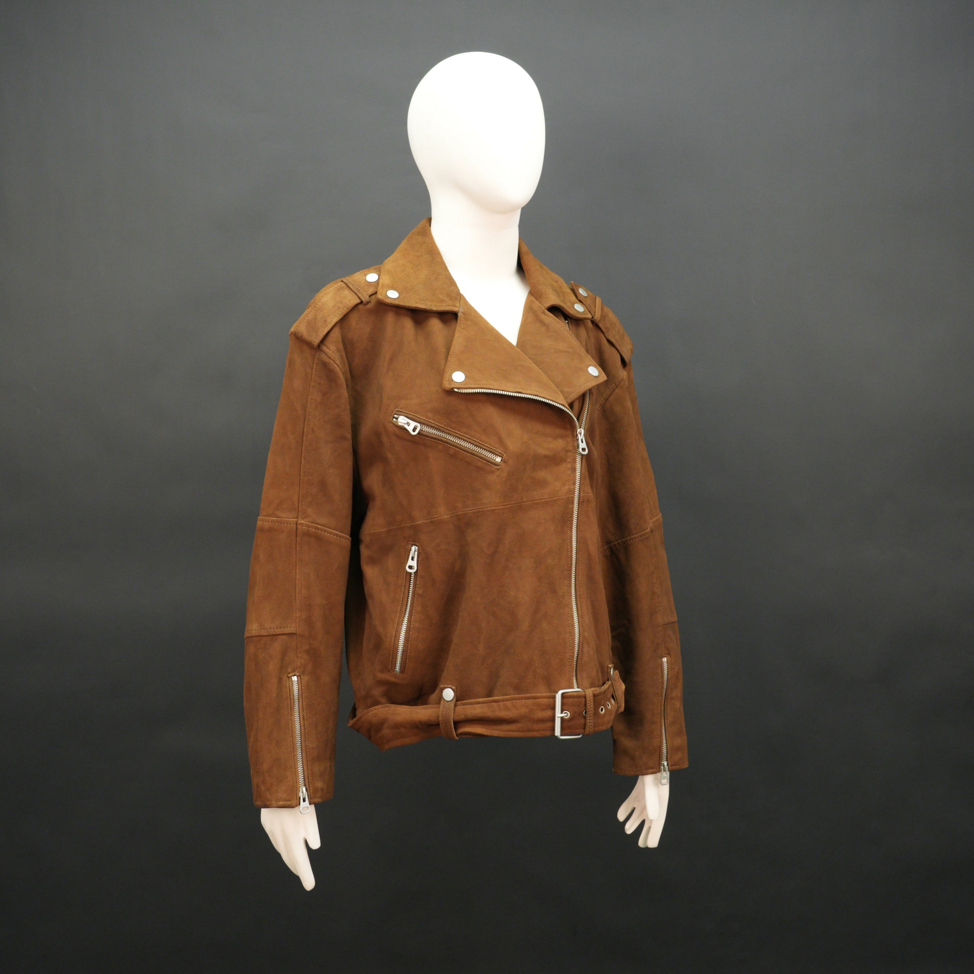 Light brown goat suede perfecto jacket with leather-look finish, soft texture, three exterior pockets, side zip pocket, and adjustable zipped cuffs. Minor fault, no returns