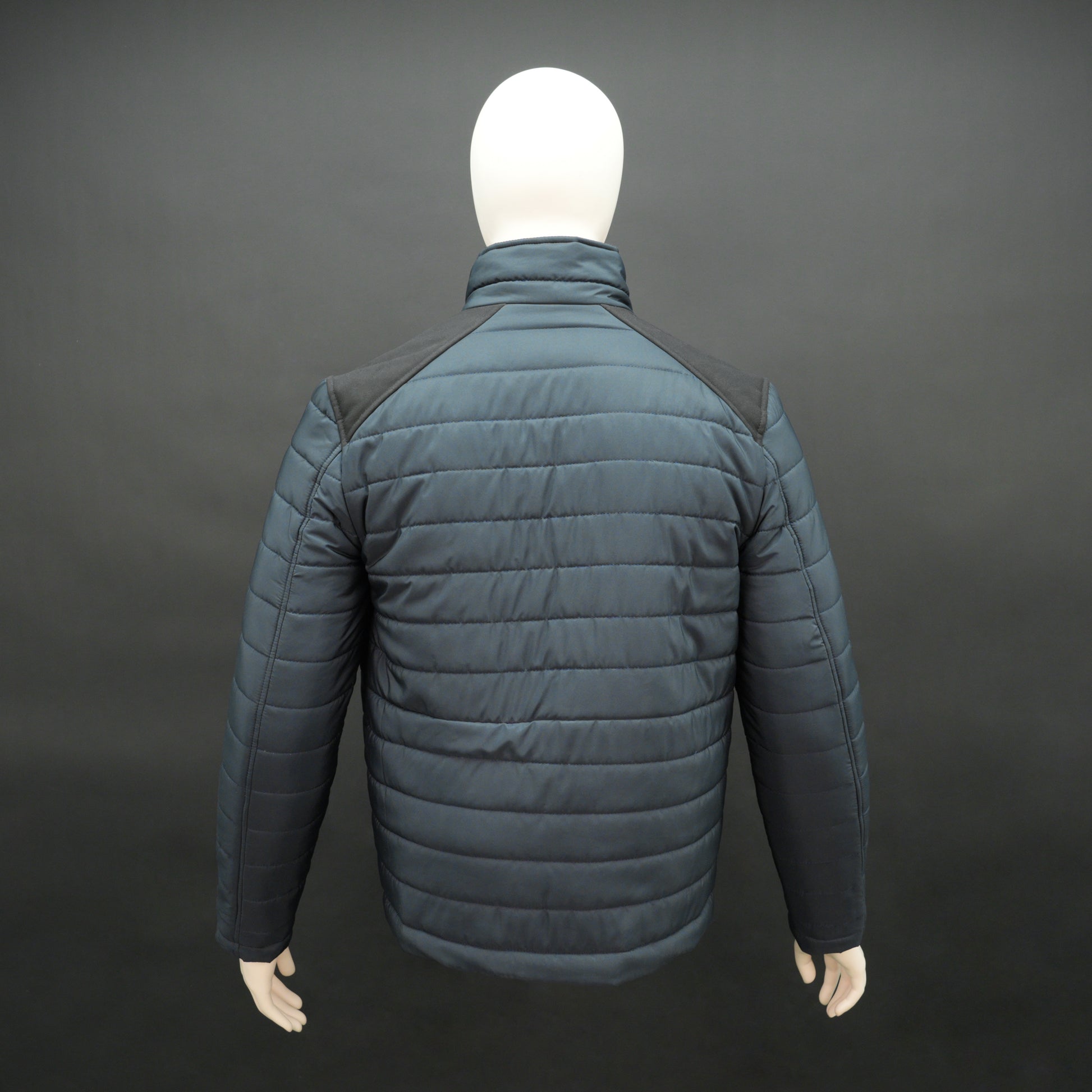 Navy full-sleeve two-tone puffer jacket with snap pockets, quilted insulation, inner compartments, and zip closure