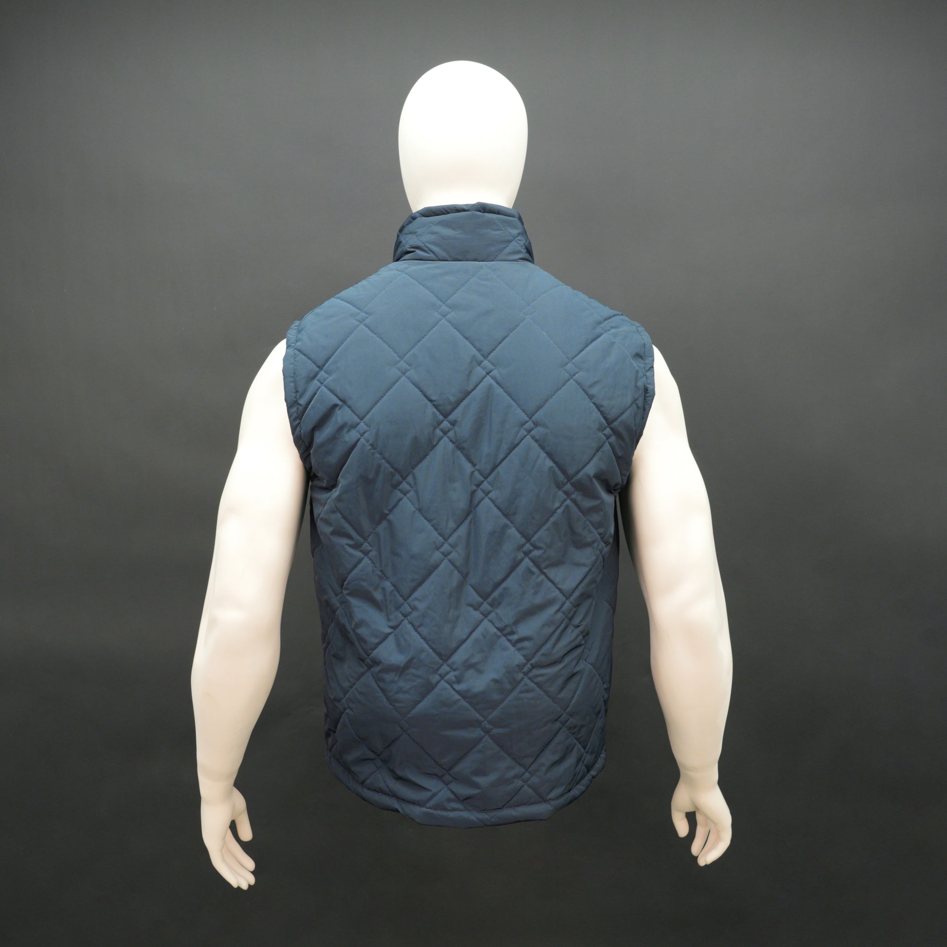 Lightweight navy sleeveless puffer vest with zip closure, side and inside pockets, for layering
