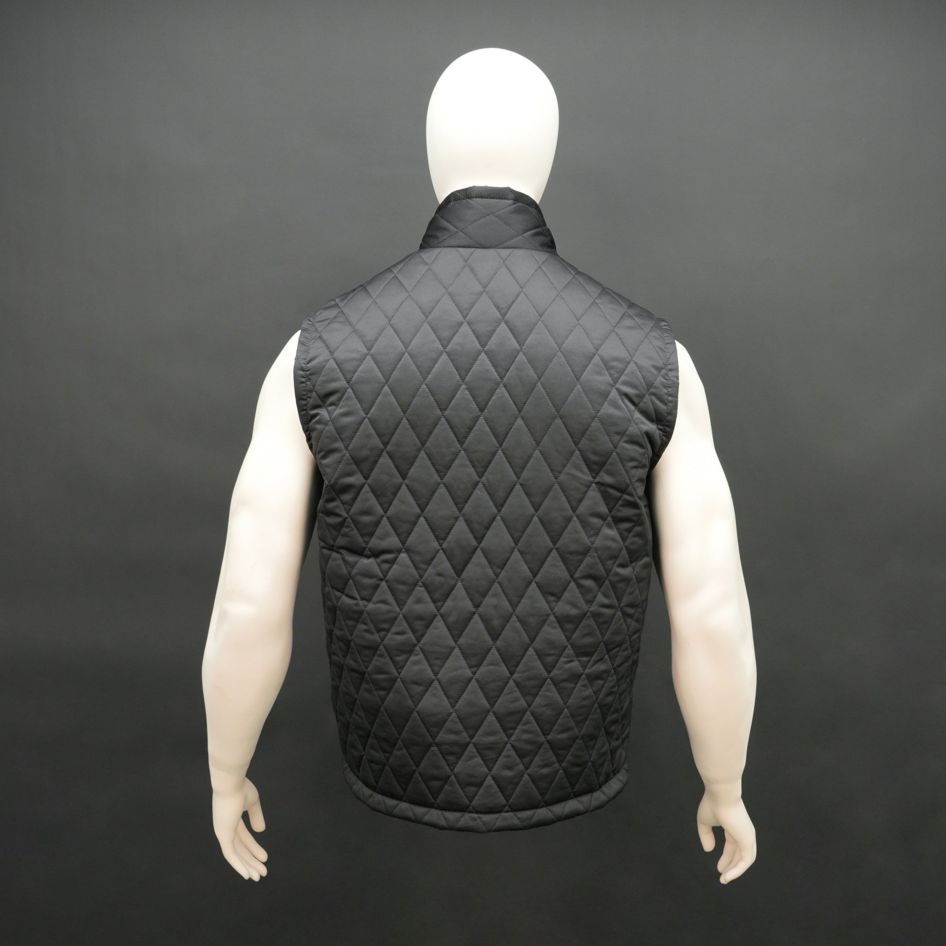 Lightweight black quilted sleeveless  puffer vest with zip closure, side and inside pockets, ideal for layering
