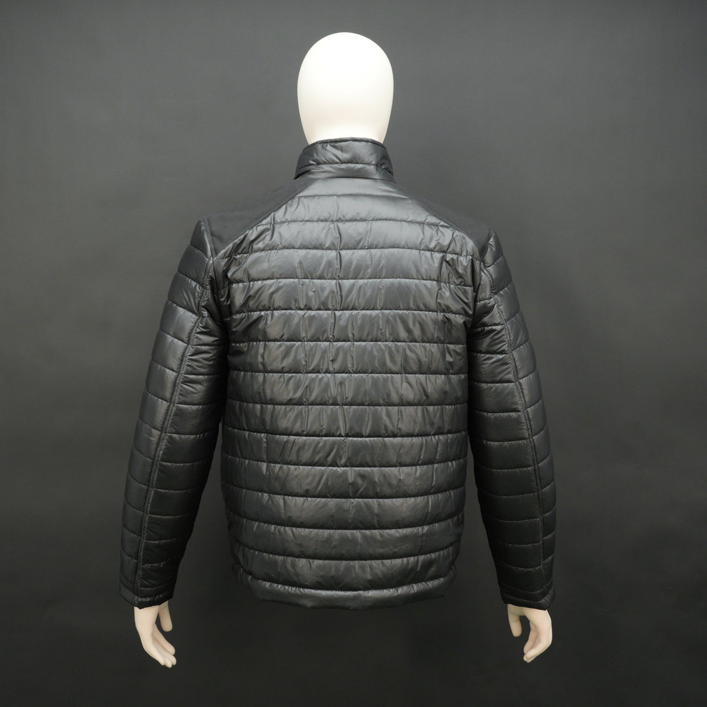 Black full-sleeve two-tone puffer jacket with snap pockets, quilted insulation, inner compartments, and zip closure