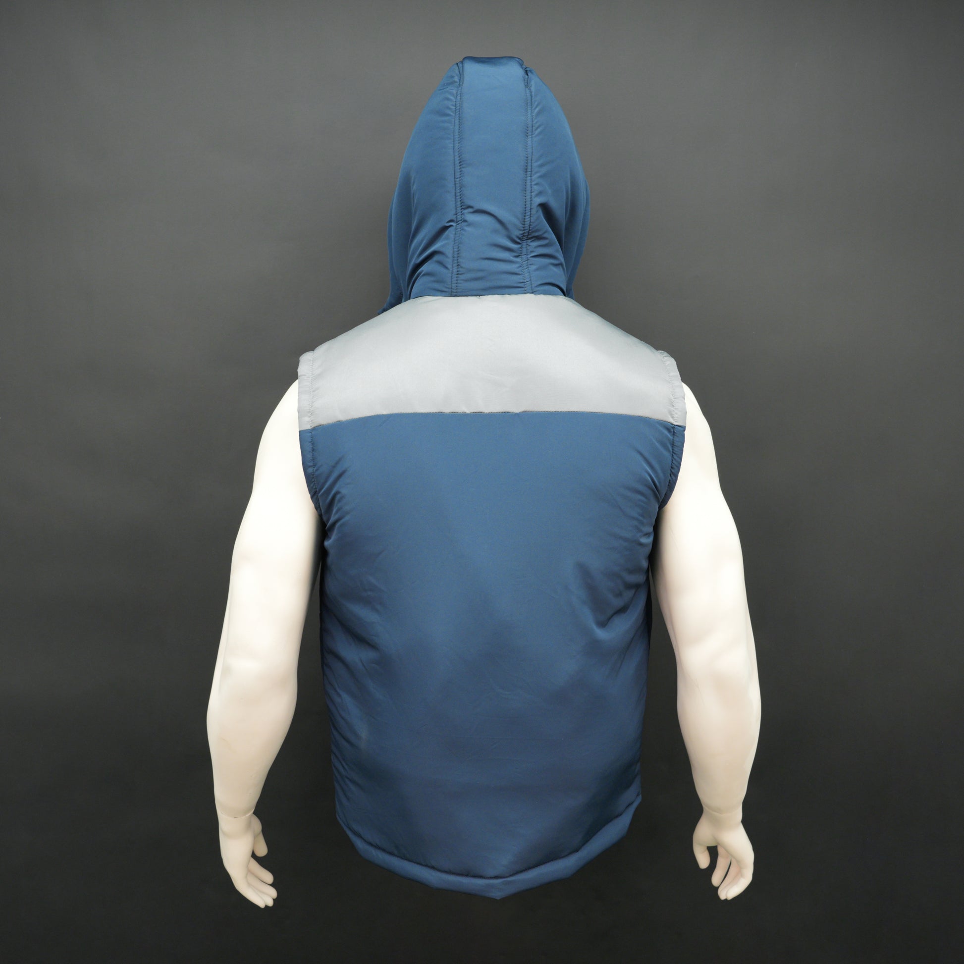 Blue-grey two-tone sleeveless puffer jacket with zip, snap buttons, hood, side and inner pockets, insulated for layering