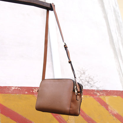 Nano cowhide leather bag in tan with minimalist silhouette, secure closure, ergonomic strap, and organized compartments for essentials