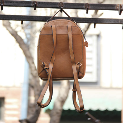 Tan genuine cowhide leather bag with minimalist design, featuring secure closures, spacious interior, and adjustable straps — crafted for durability and style