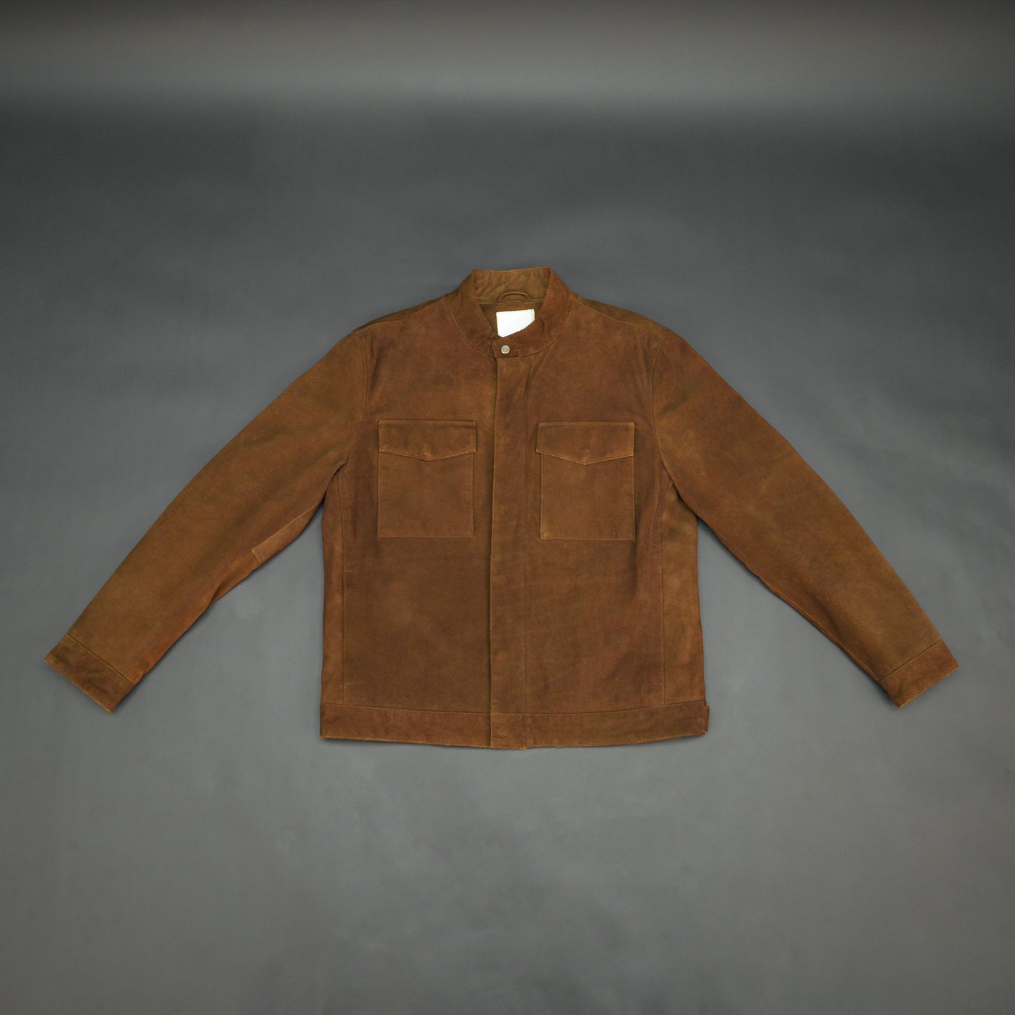 Brown suede leather jacket with front pocket and unique button and zip opening
