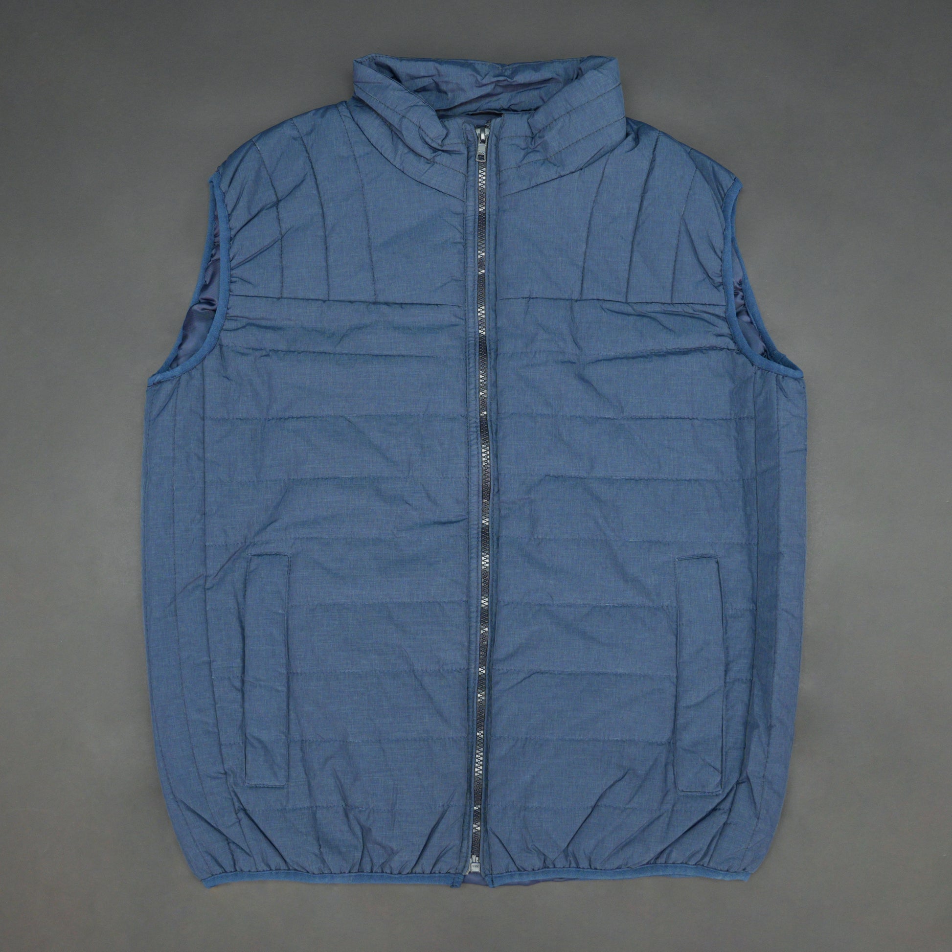 Blue garment with a full zip front, snap-button side pockets, and two interior pockets designed for secure and easy storage