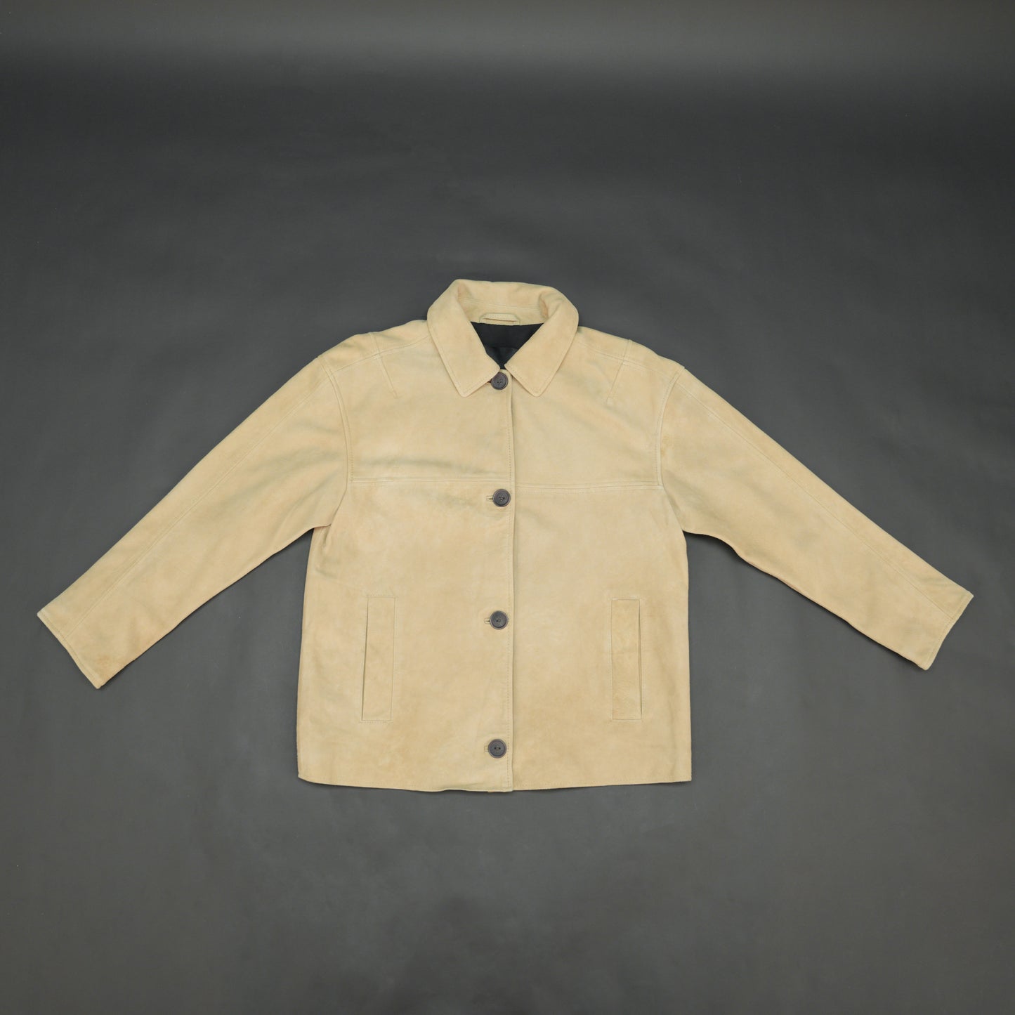 Beige suede leather jacket with tailored fit, elegant button opening, and front side pockets
