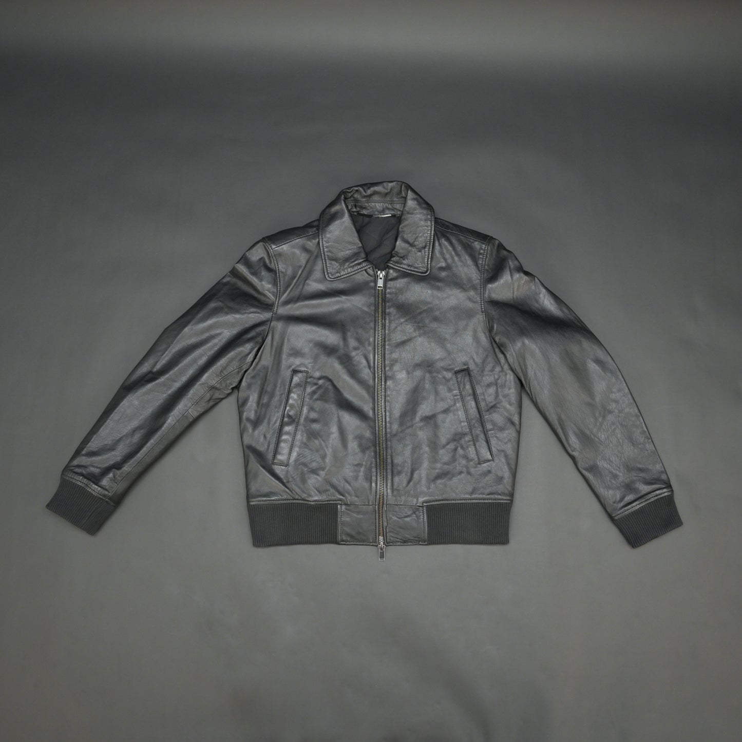 Black sheep leather jacket with soft material, front and inside pockets, and zip closure