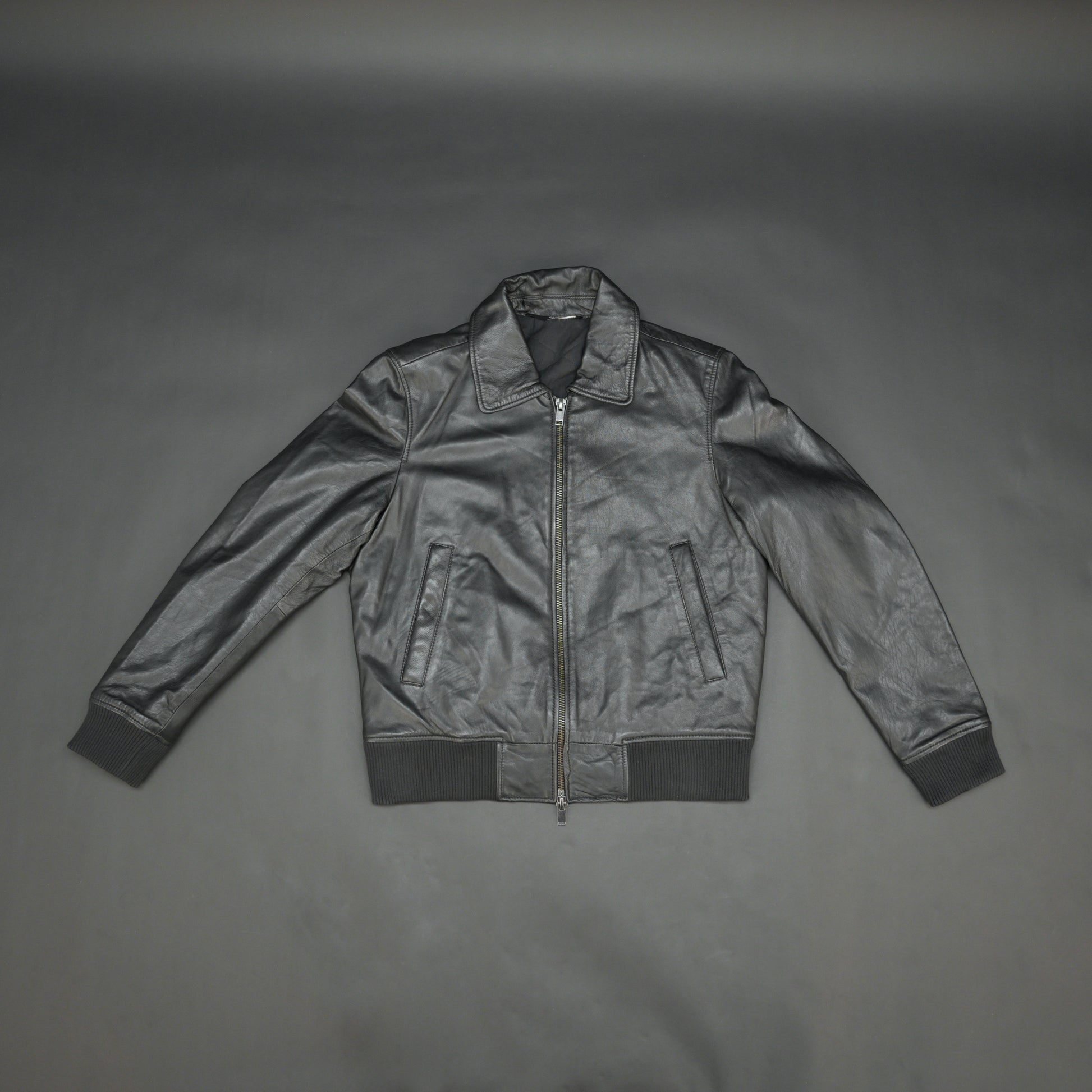 Black sheep leather jacket with soft material, front and inside pockets, and zip closure