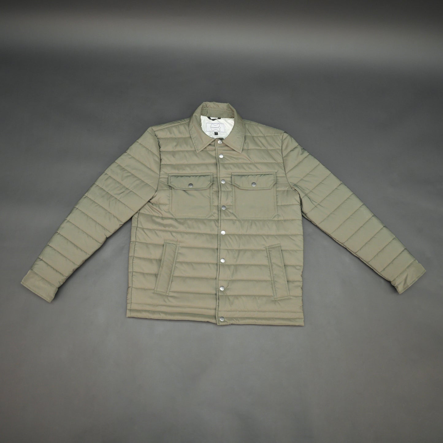 Green full-sleeve puffer jacket with snap closure, quilted padding, inner and outer pockets, designed for everyday comfort.