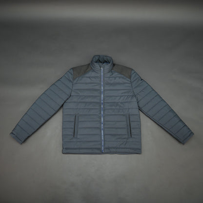 Navy full-sleeve two-tone puffer jacket with snap pockets, quilted insulation, inner compartments, and zip closure