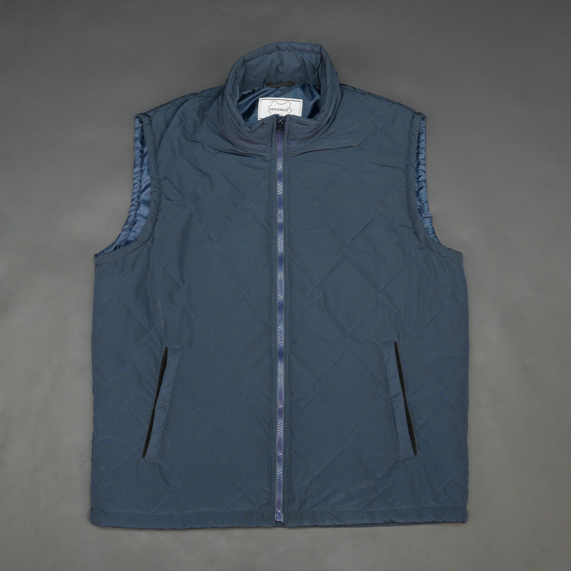 Lightweight navy sleeveless puffer vest with zip closure, side and inside pockets, for layering