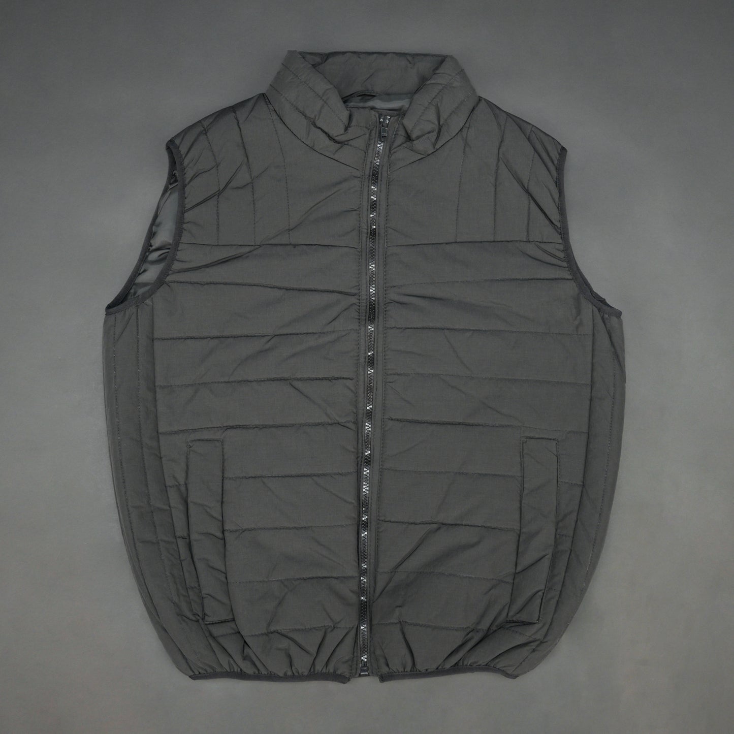 Black garment featuring a front zip closure, two snap-button side pockets, and two inside pockets for secure, convenient storage