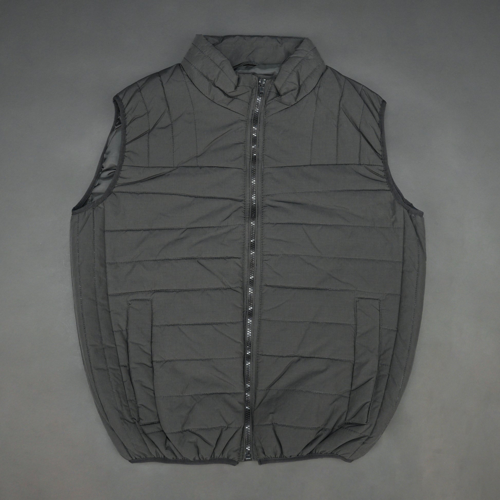 Black garment featuring a front zip closure, two snap-button side pockets, and two inside pockets for secure, convenient storage