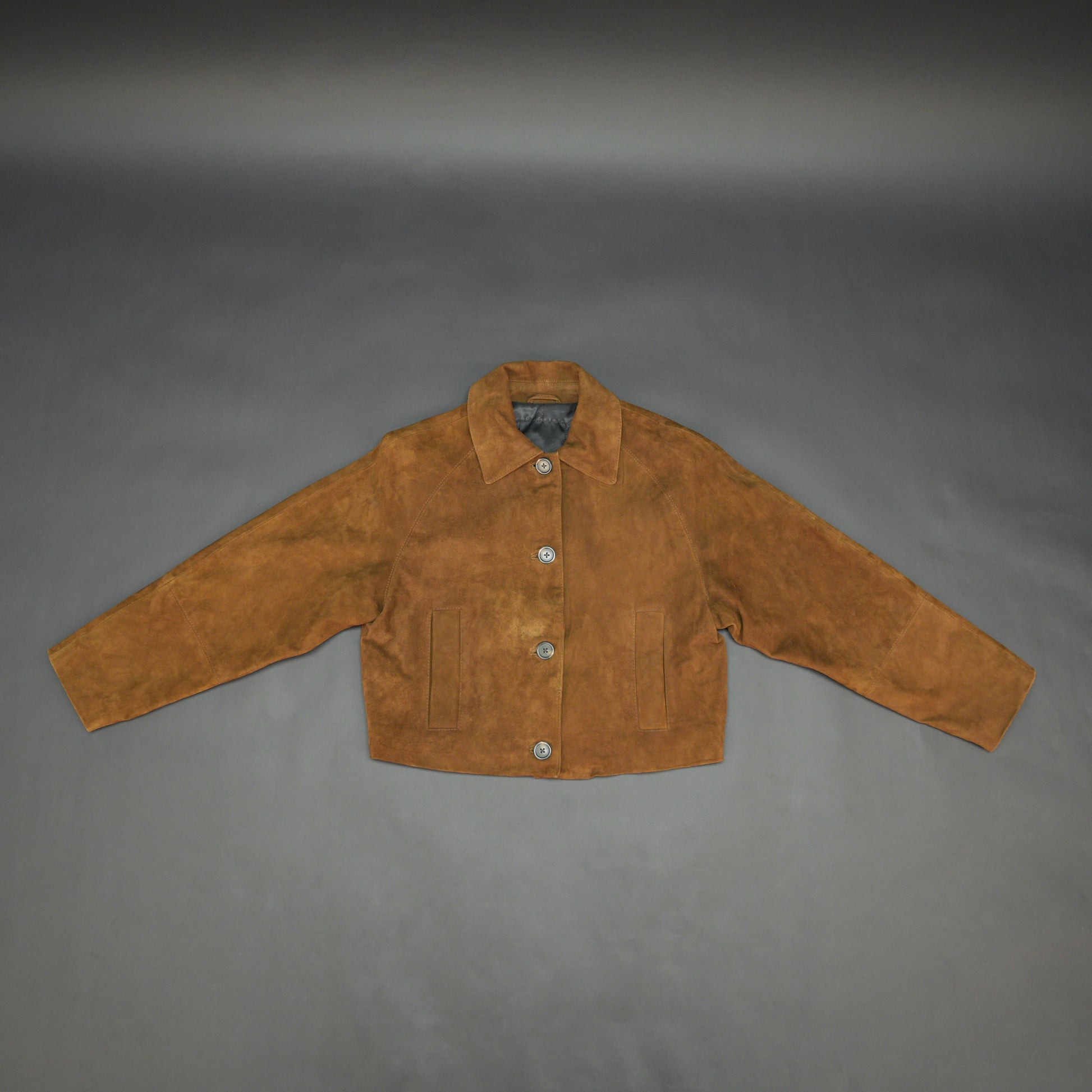 Brown suede leather jacket with button closure, slim fit, side pockets, and soft premium suede finish