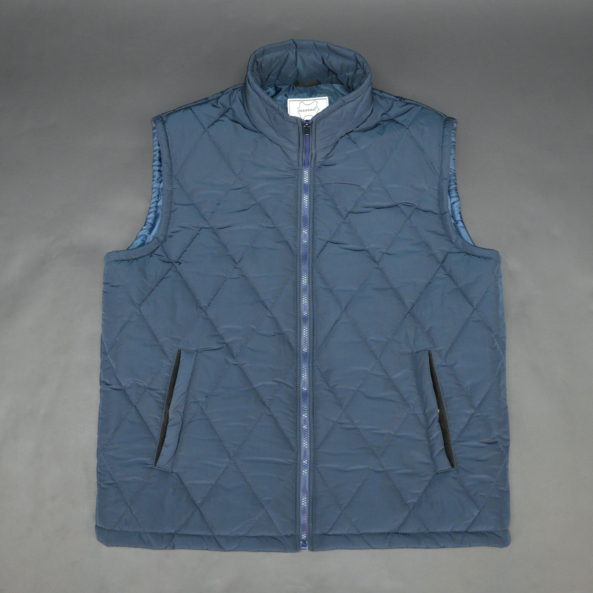 Navy sleeveless puffer vest with zip, side and inside pockets, lightweight for layering