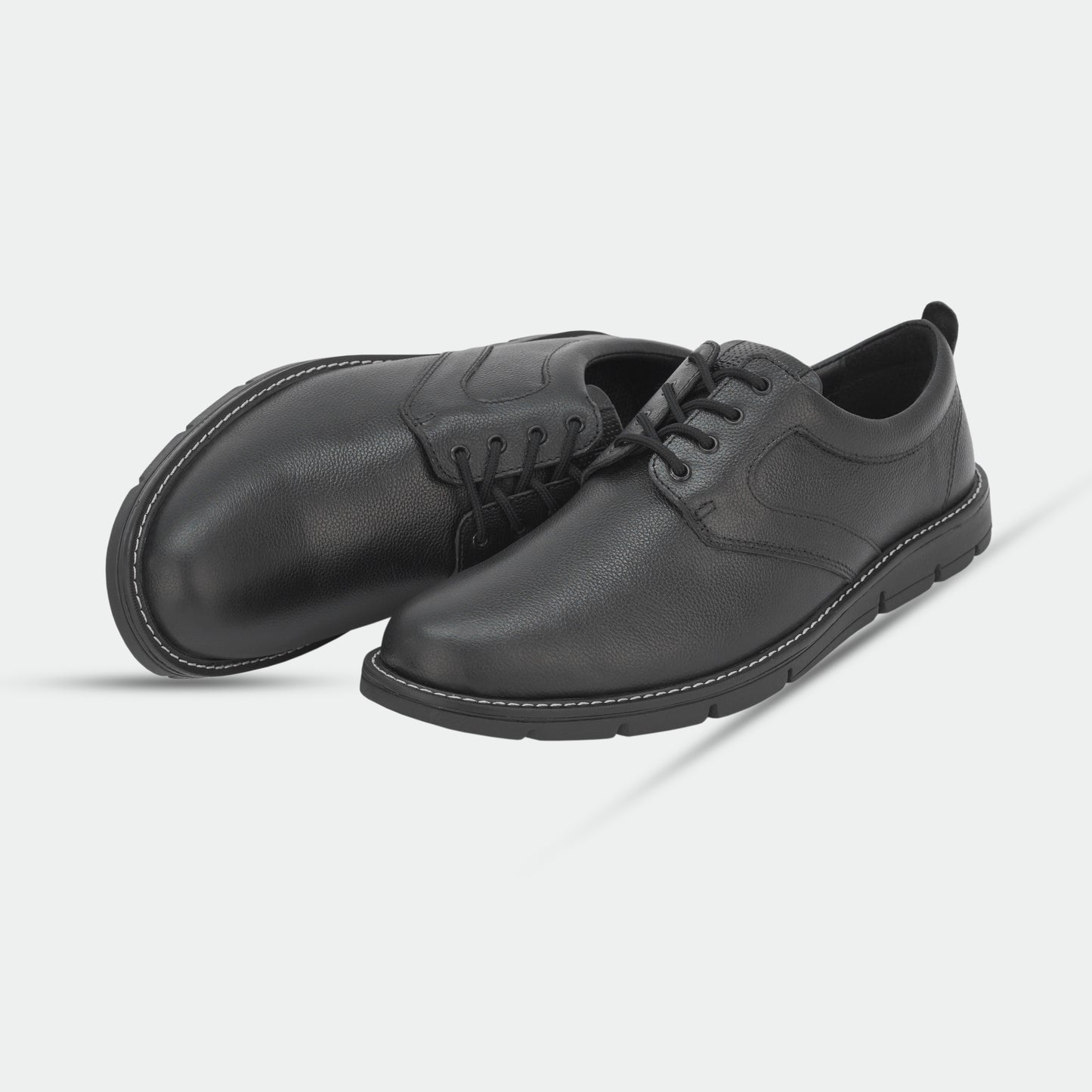 Black footwear featuring genuine cow leather milled commute upper, soft sheep lining, Taxon insole for stability, and lightweight EVA sole for comfort and grip