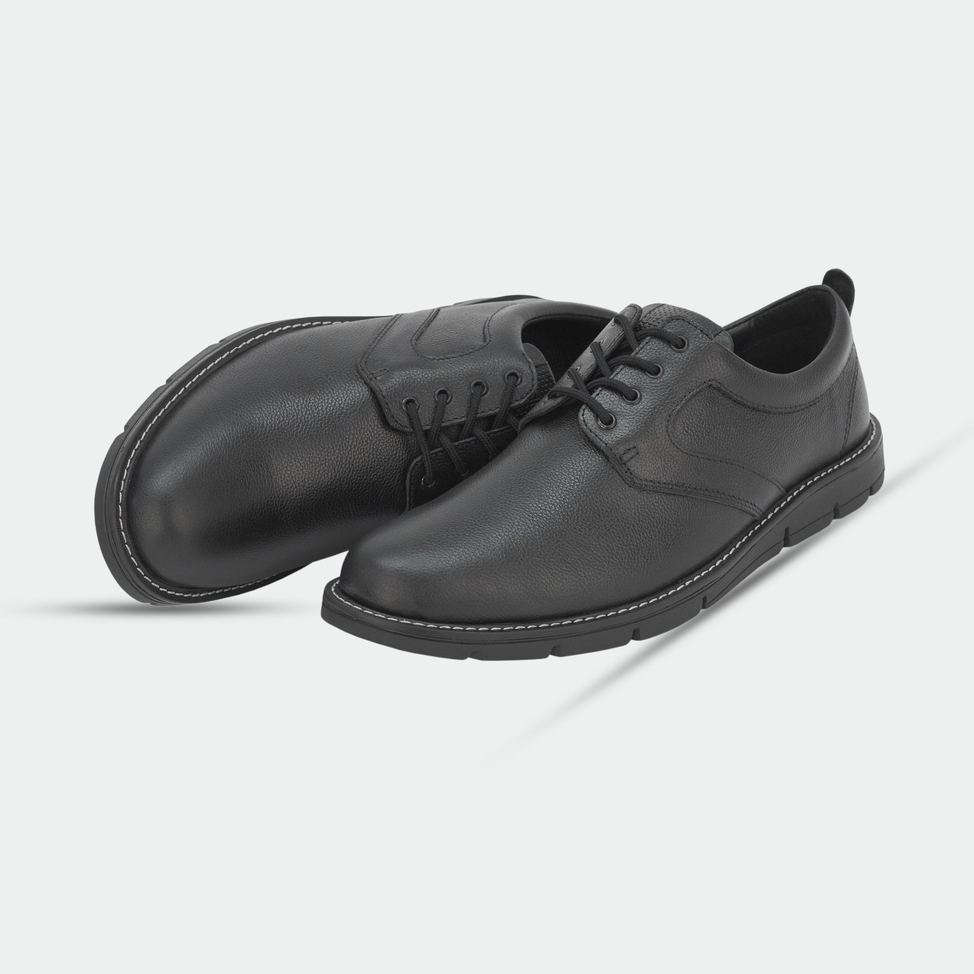 Black footwear featuring genuine cow leather milled commute upper, soft sheep lining, Taxon insole for stability, and lightweight EVA sole for comfort and grip