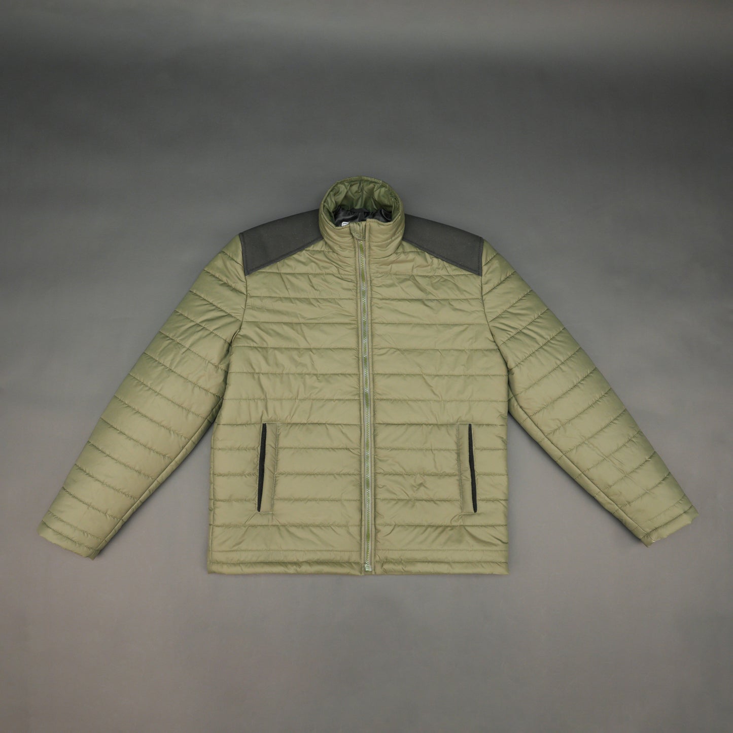 Green full-sleeve two-tone puffer jacket with snap pockets, quilted insulation, inner compartments, and zip closure