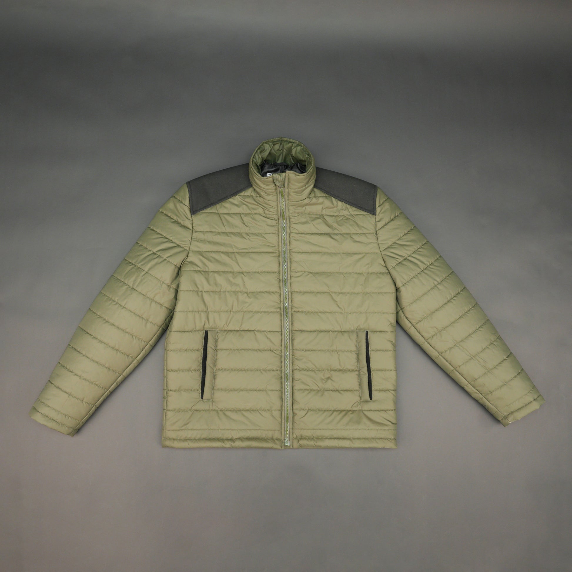 Green full-sleeve two-tone puffer jacket with snap pockets, quilted insulation, inner compartments, and zip closure