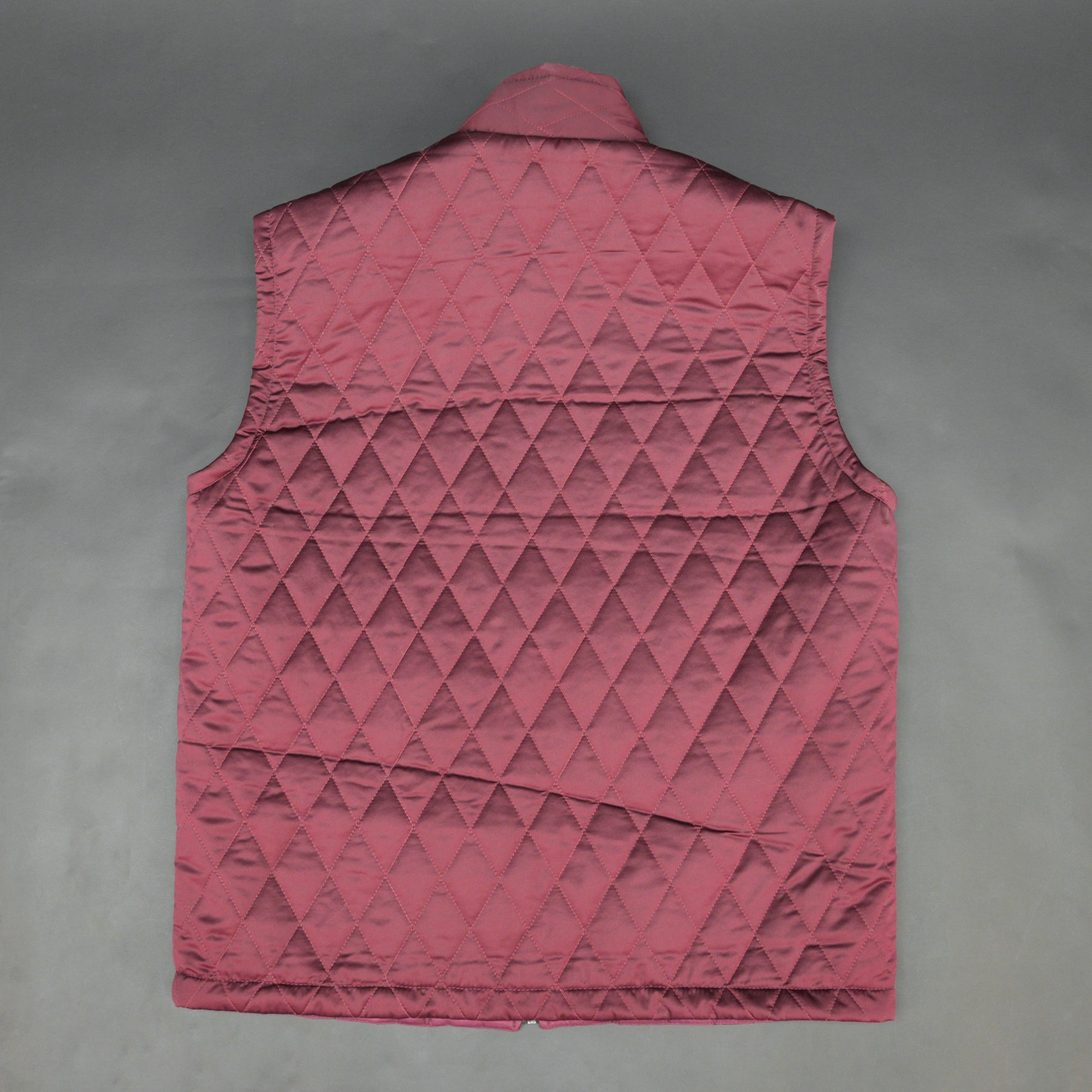 Maroon quilted sleeveless  puffer vest with zip closure, side and inside pockets, ideal for layering