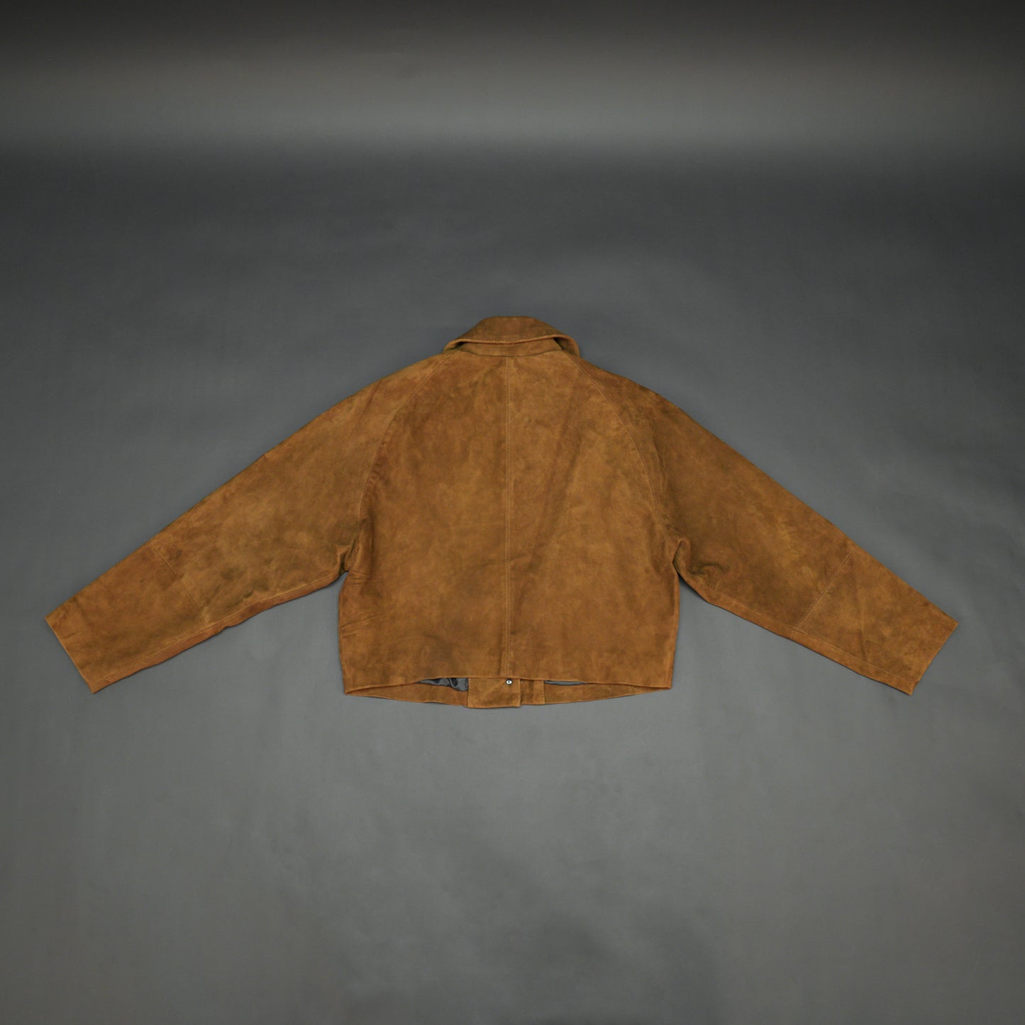 Brown suede leather jacket with button closure, slim fit, side pockets, and soft premium suede finish