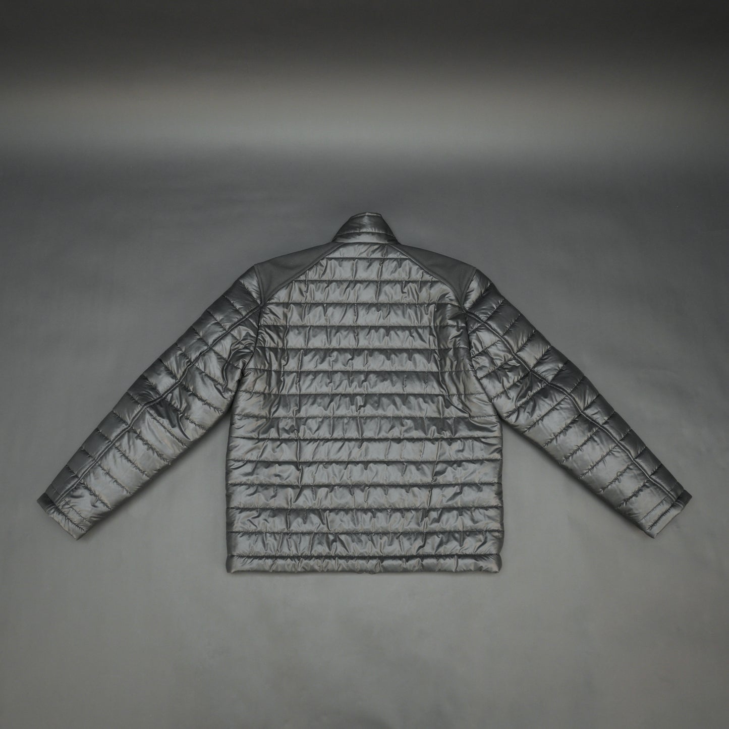 Black full-sleeve two-tone puffer jacket with snap pockets, quilted insulation, inner compartments, and zip closure