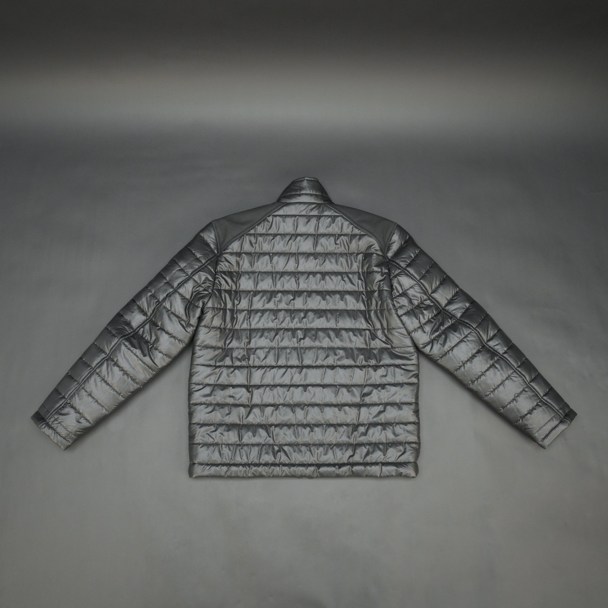 Black full-sleeve two-tone puffer jacket with snap pockets, quilted insulation, inner compartments, and zip closure