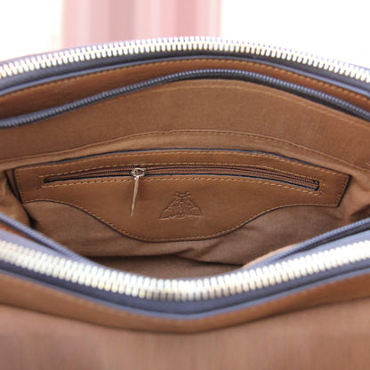 Nano cowhide leather bag in tan with minimalist silhouette, secure closure, ergonomic strap, and organized compartments for essentials