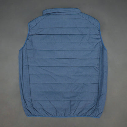 Blue garment with a full zip front, snap-button side pockets, and two interior pockets designed for secure and easy storage