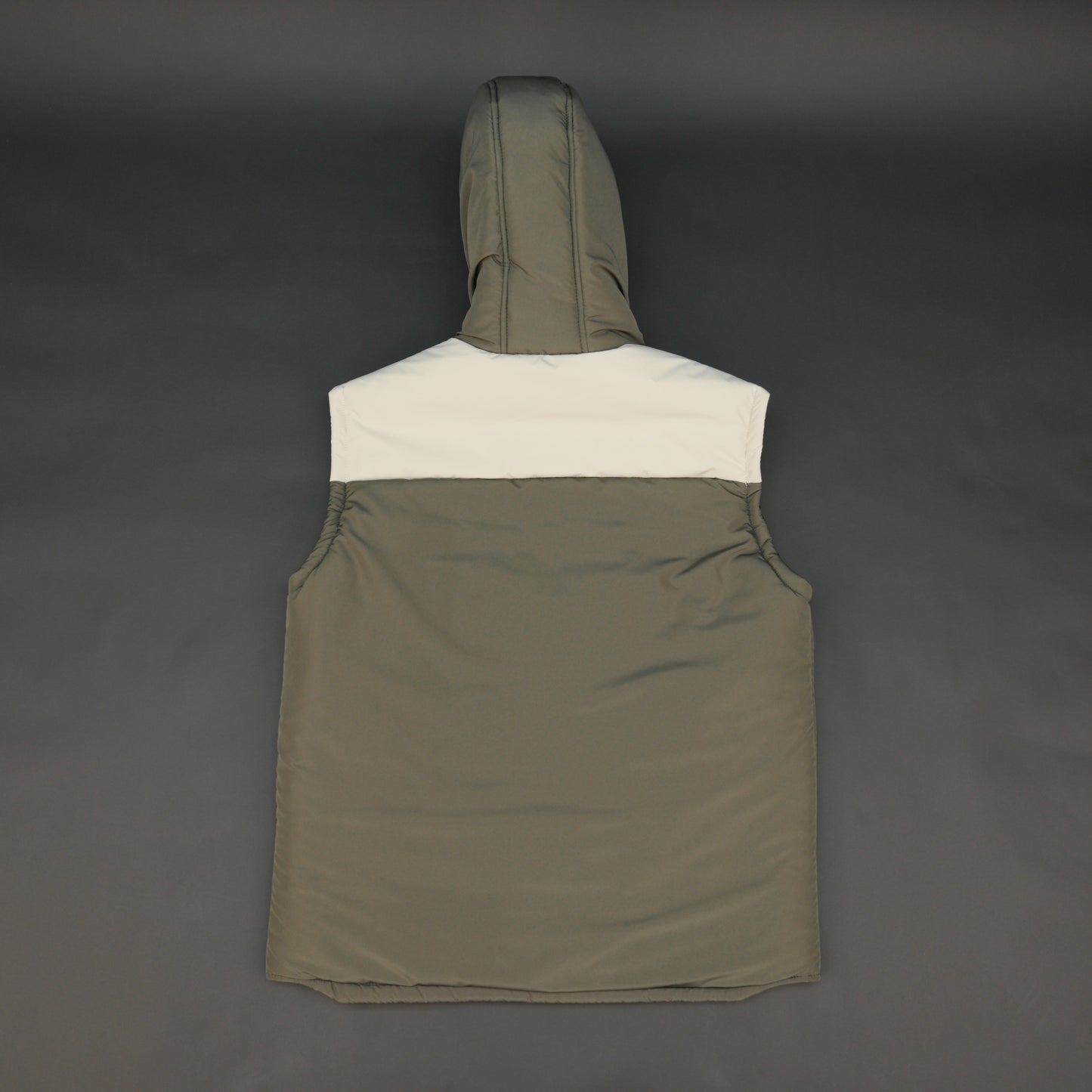 Green-cream sleeveless puffer jacket with zip and snap closure, hood, side and inner pockets, quilted for transitional seasons.