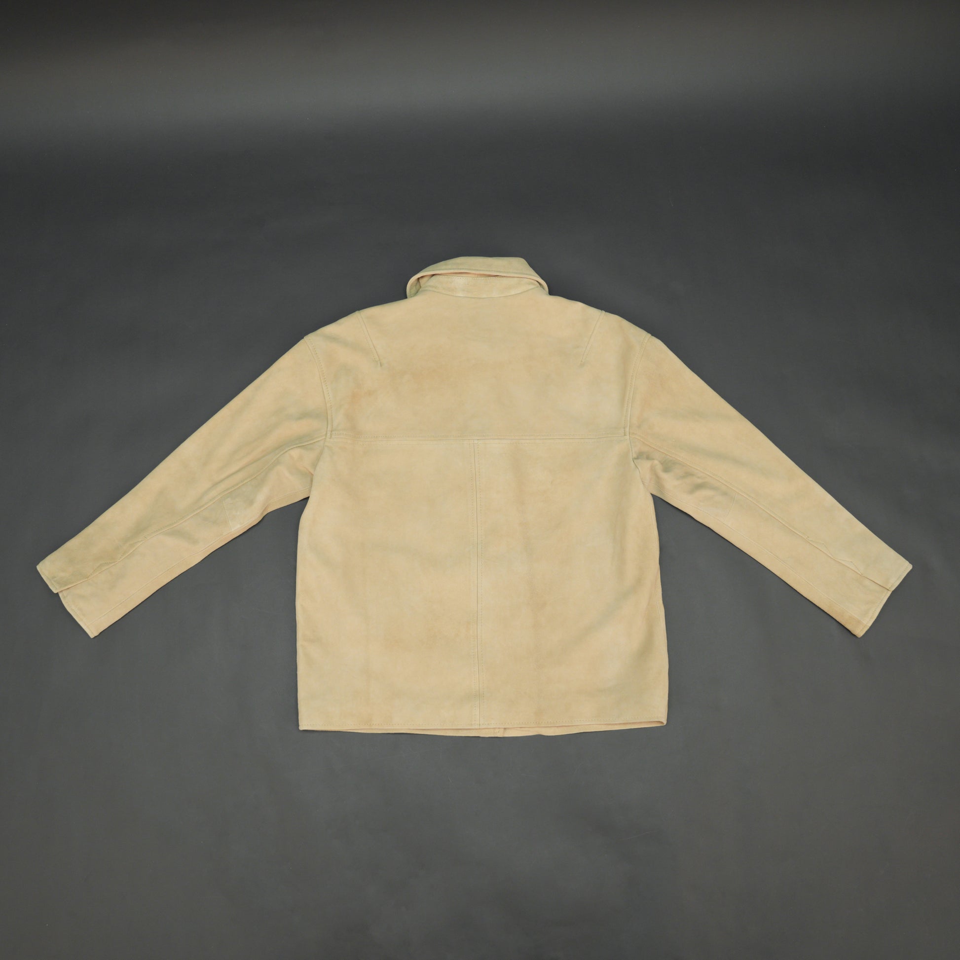 Beige suede leather jacket with tailored fit, elegant button opening, and front side pockets