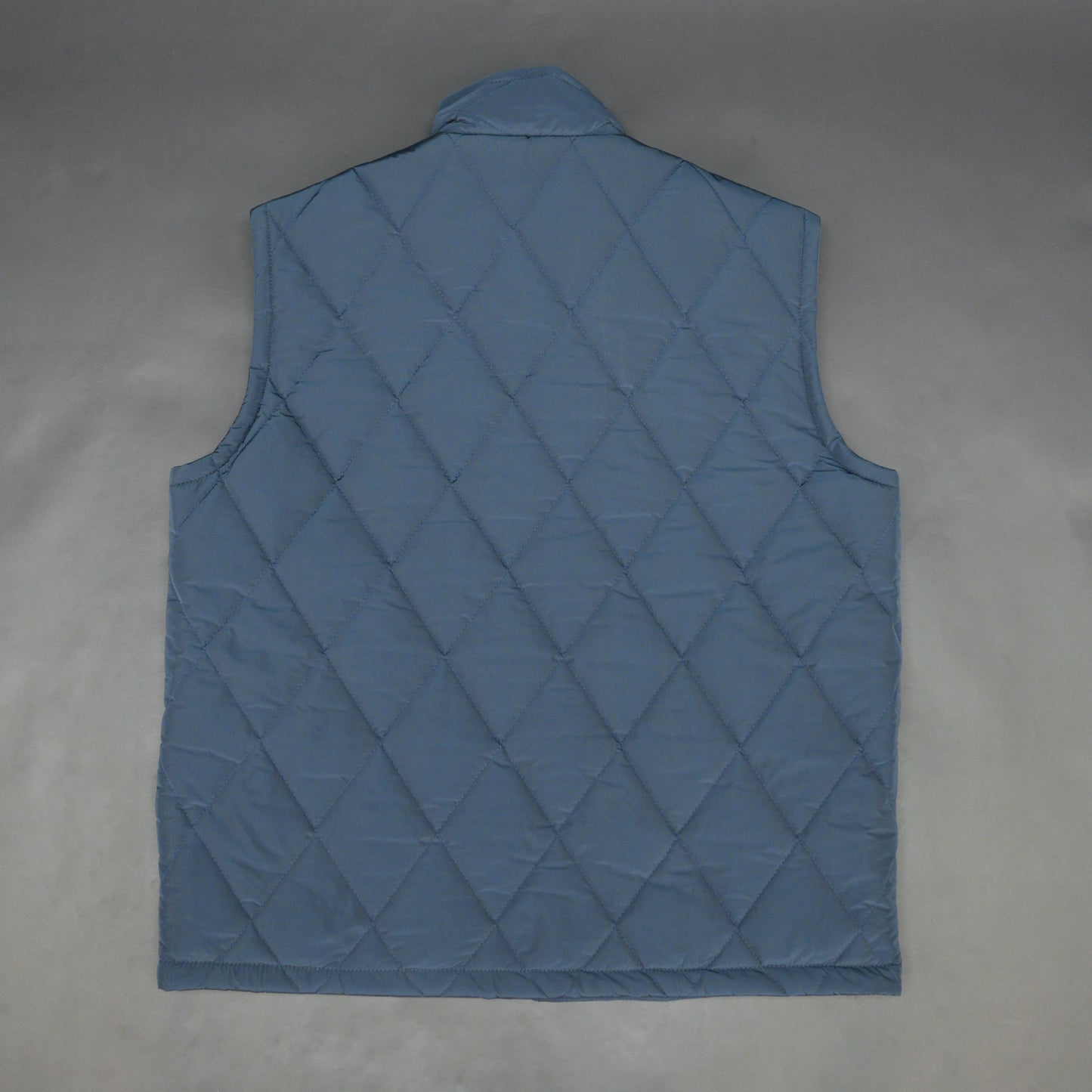 Navy sleeveless puffer vest with zip, side and inside pockets, lightweight for layering