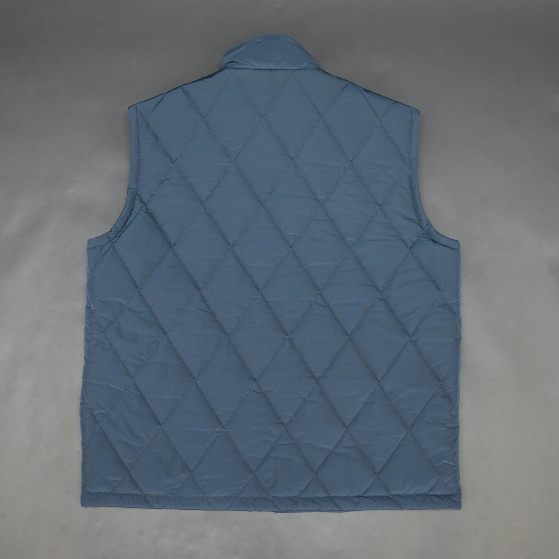 Navy sleeveless puffer vest with zip, side and inside pockets, lightweight for layering