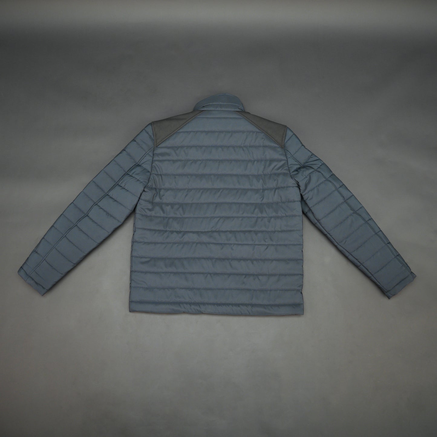 Navy full-sleeve two-tone puffer jacket with snap pockets, quilted insulation, inner compartments, and zip closure