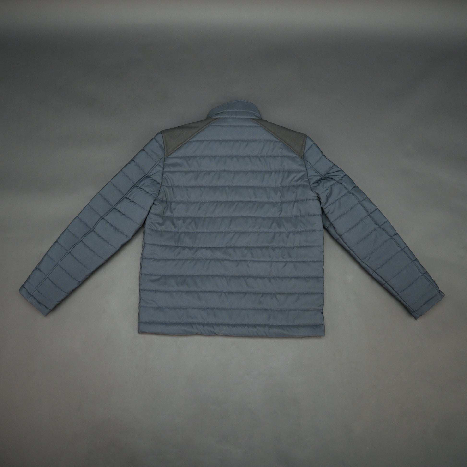 Navy full-sleeve two-tone puffer jacket with snap pockets, quilted insulation, inner compartments, and zip closure