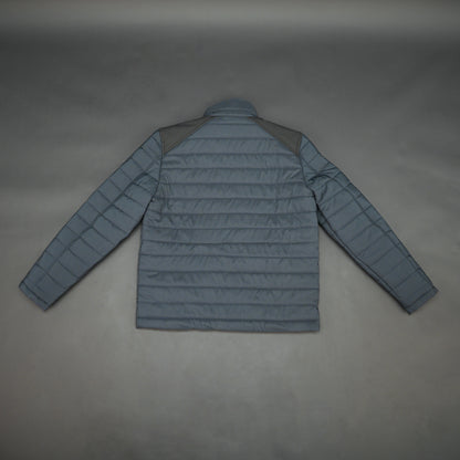 Navy full-sleeve two-tone puffer jacket with snap pockets, quilted insulation, inner compartments, and zip closure